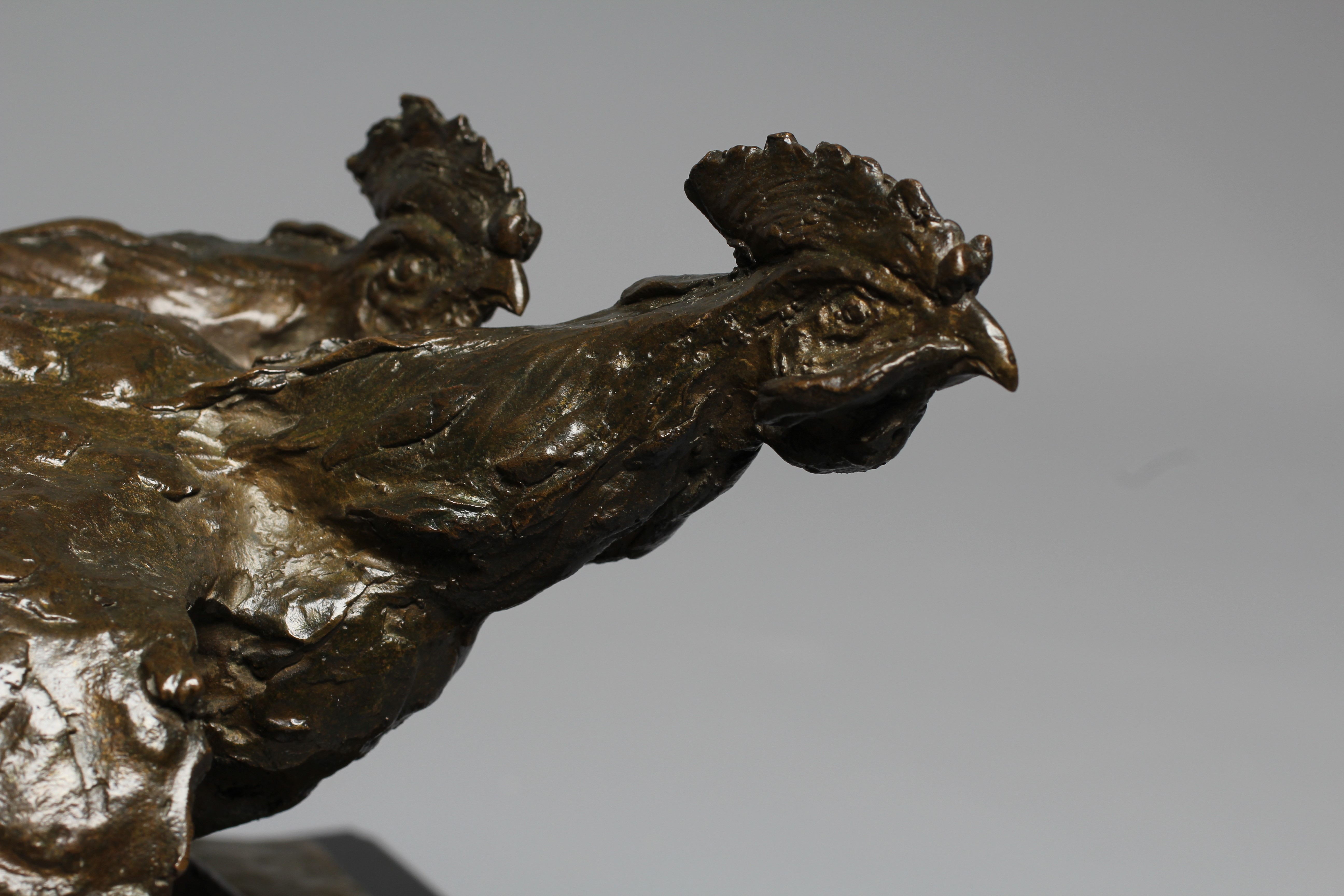 A 20TH CENTURY BRONZE OF TWO COCKERELS FIGHTING with dark brown patina, on an oblong polished slate Image