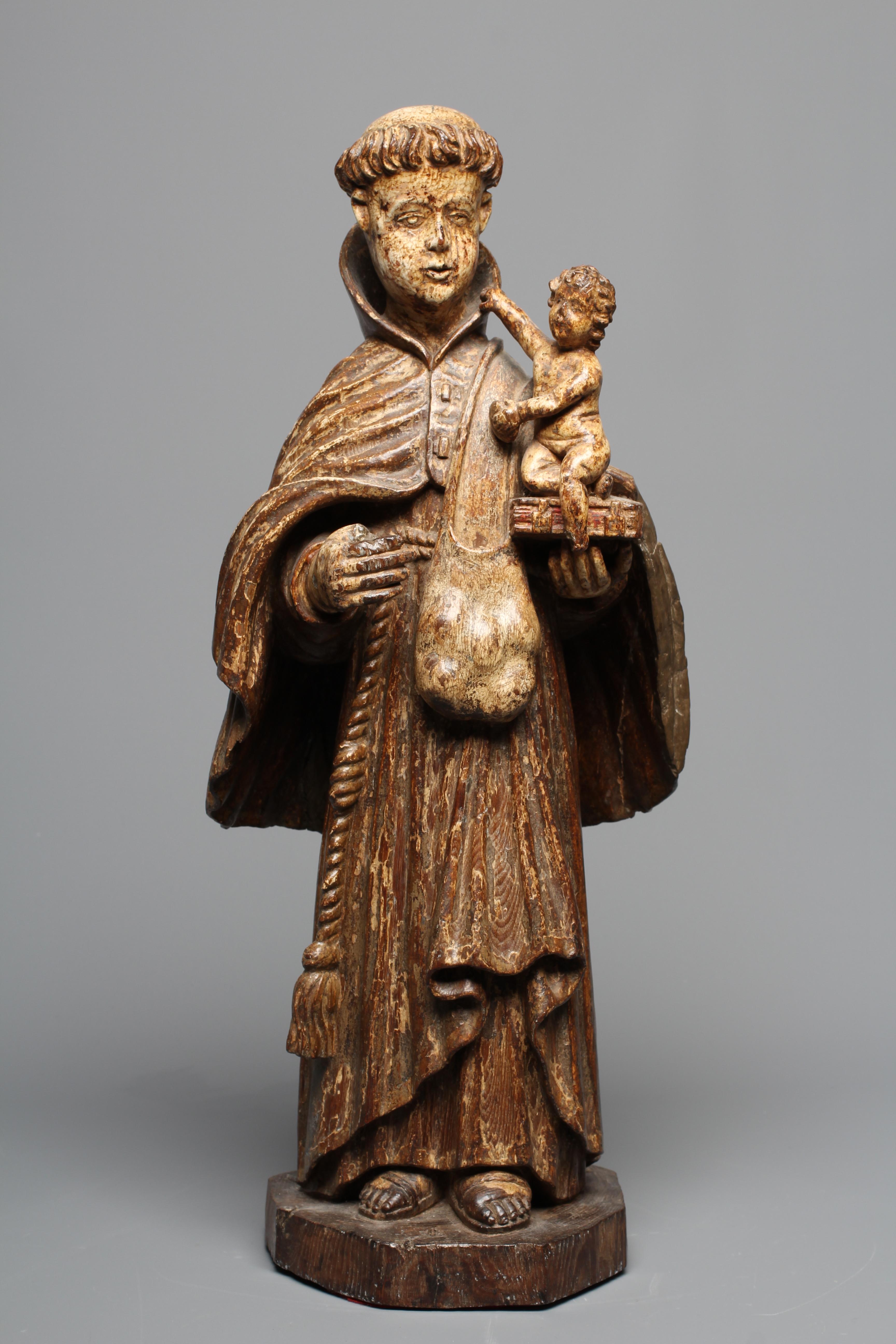 A CARVED WOOD AND PAINTED FIGURE OF ST ANTHONY OF PADUA, 17th century, modelled standing and with a Image