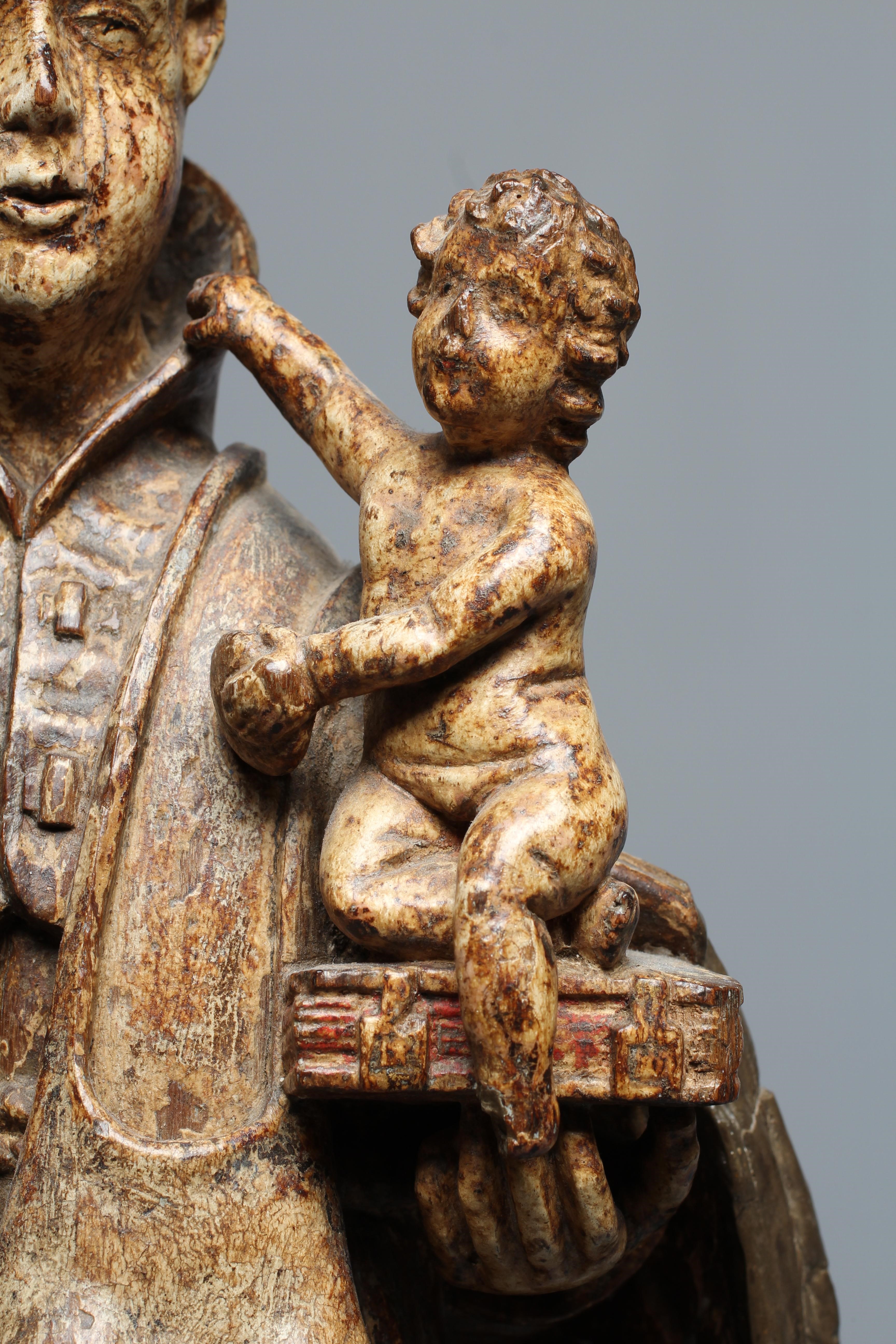 A CARVED WOOD AND PAINTED FIGURE OF ST ANTHONY OF PADUA, 17th century, modelled standing and with a Image