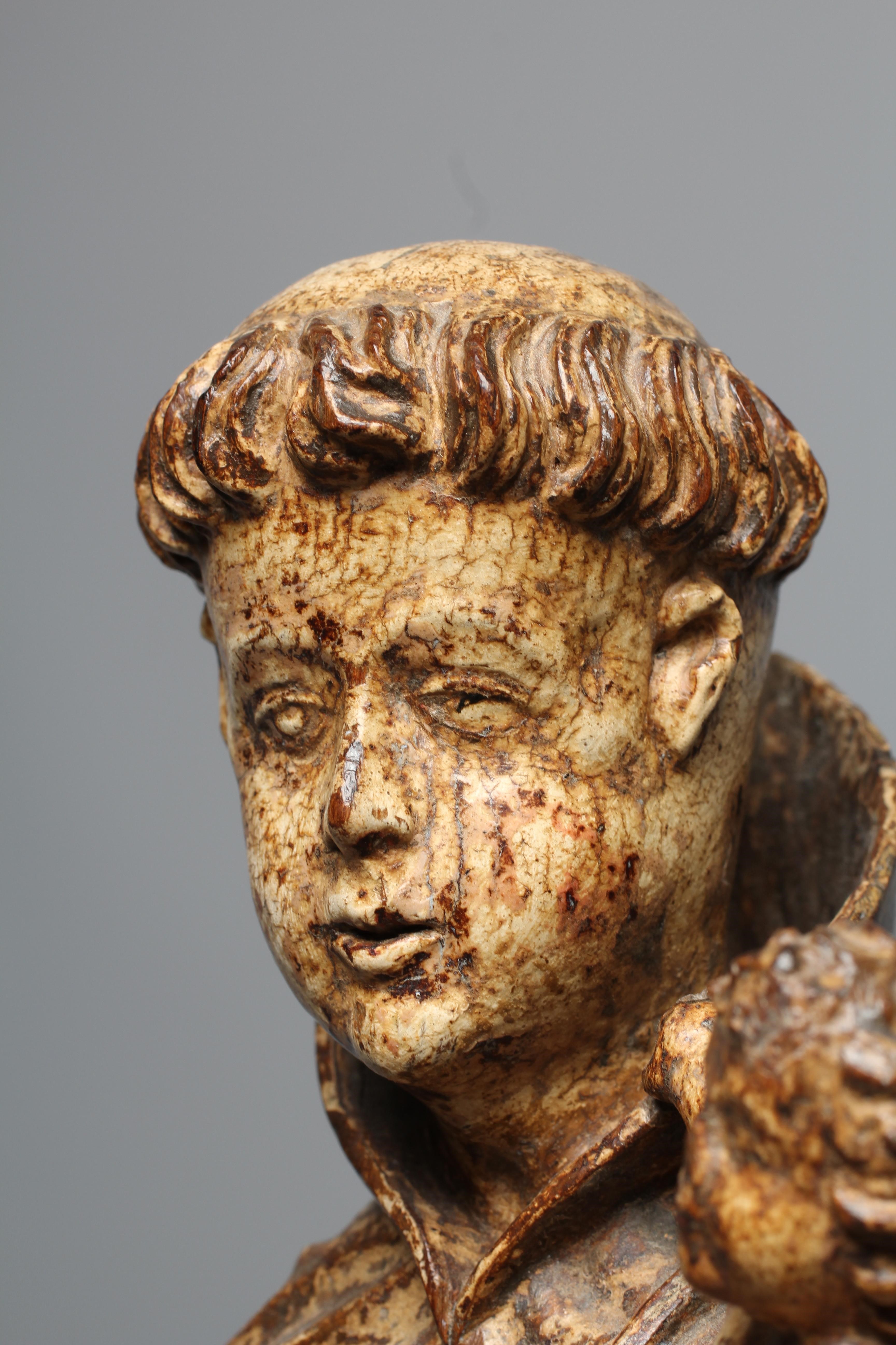 A CARVED WOOD AND PAINTED FIGURE OF ST ANTHONY OF PADUA, 17th century, modelled standing and with a Image
