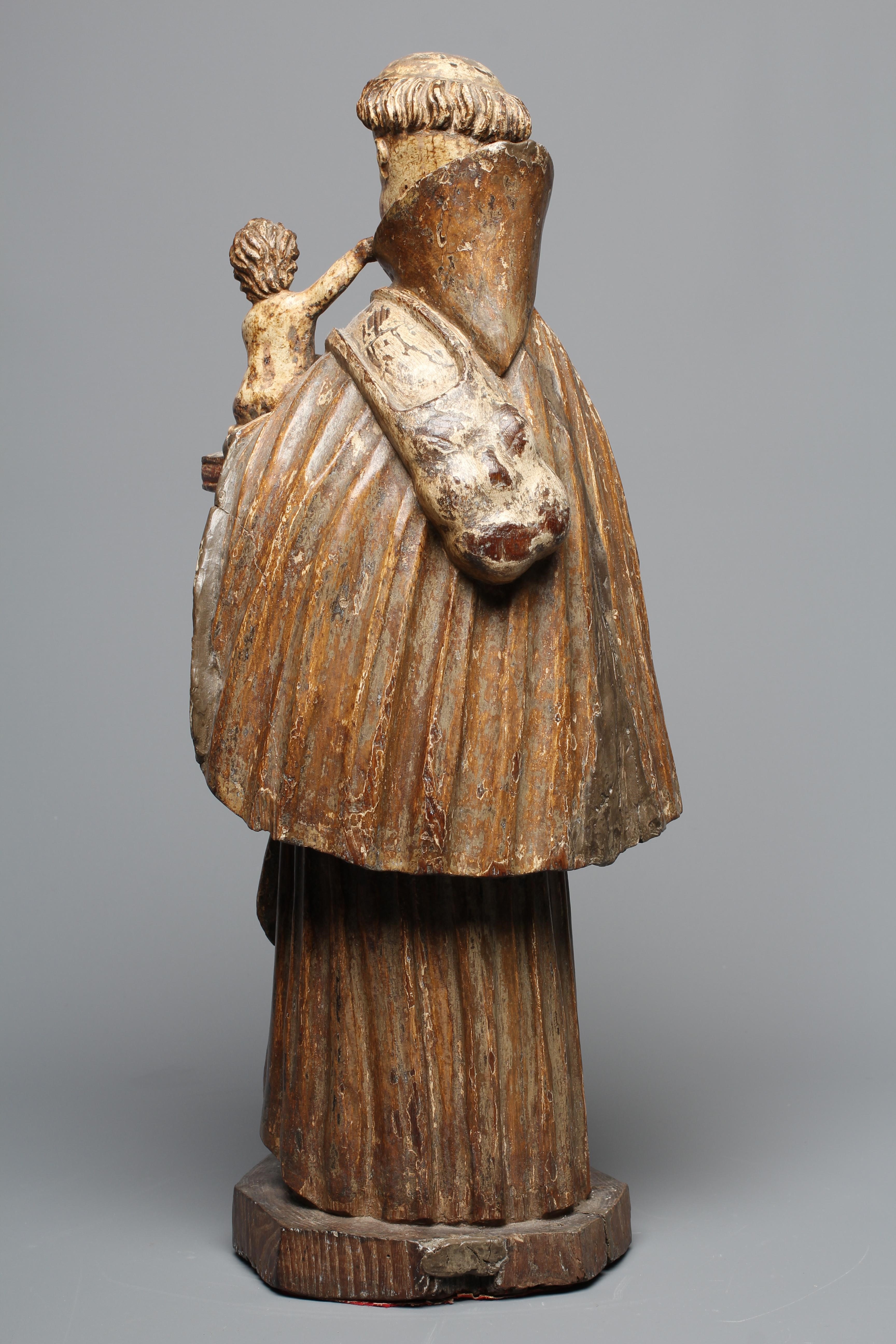 A CARVED WOOD AND PAINTED FIGURE OF ST ANTHONY OF PADUA, 17th century, modelled standing and with a Image