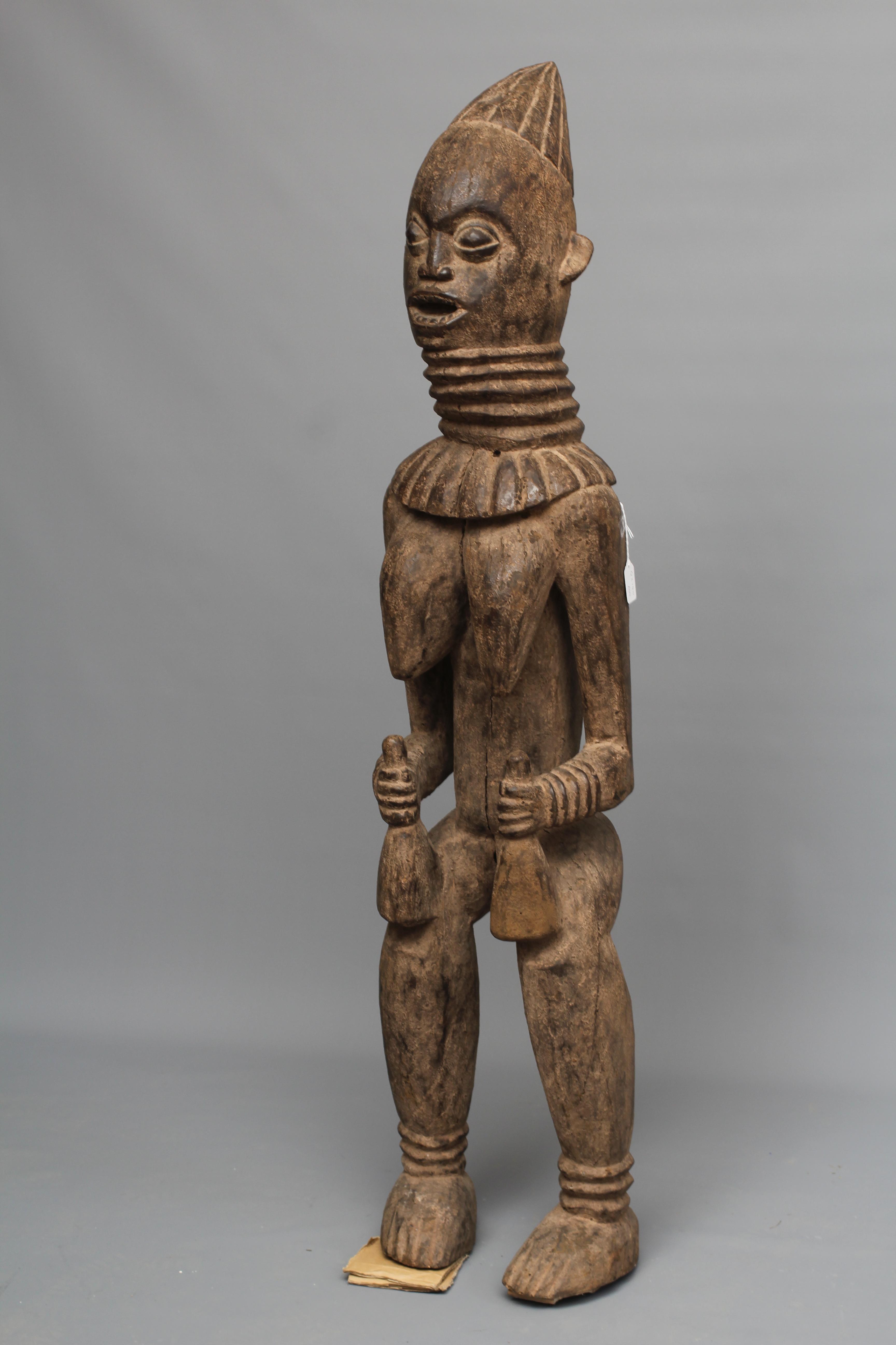 A BAULE FERTILITY FIGURE, Ivory Coast, carved with braided coiffure, neck rings, arms free to the Image