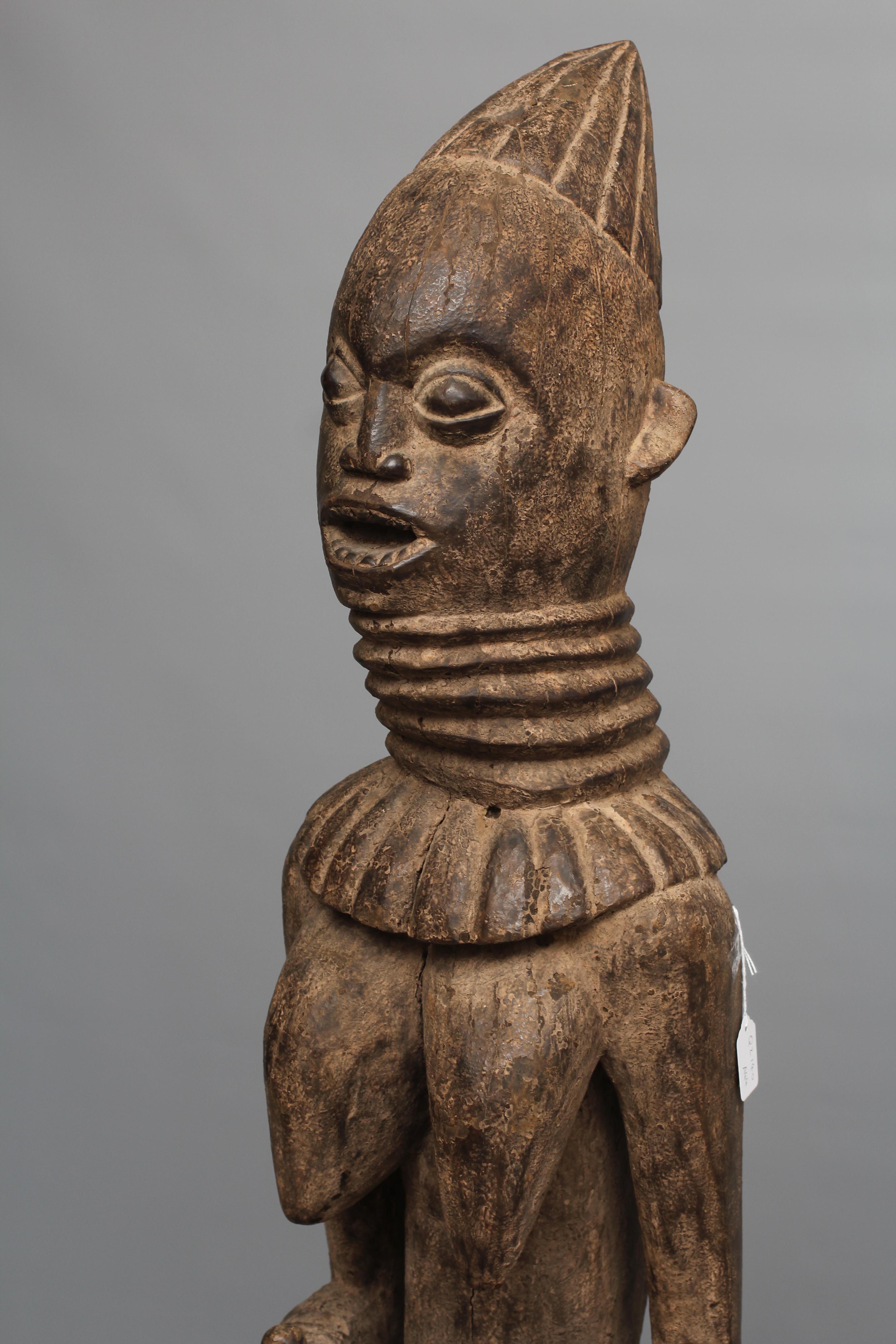 A BAULE FERTILITY FIGURE, Ivory Coast, carved with braided coiffure, neck rings, arms free to the Image