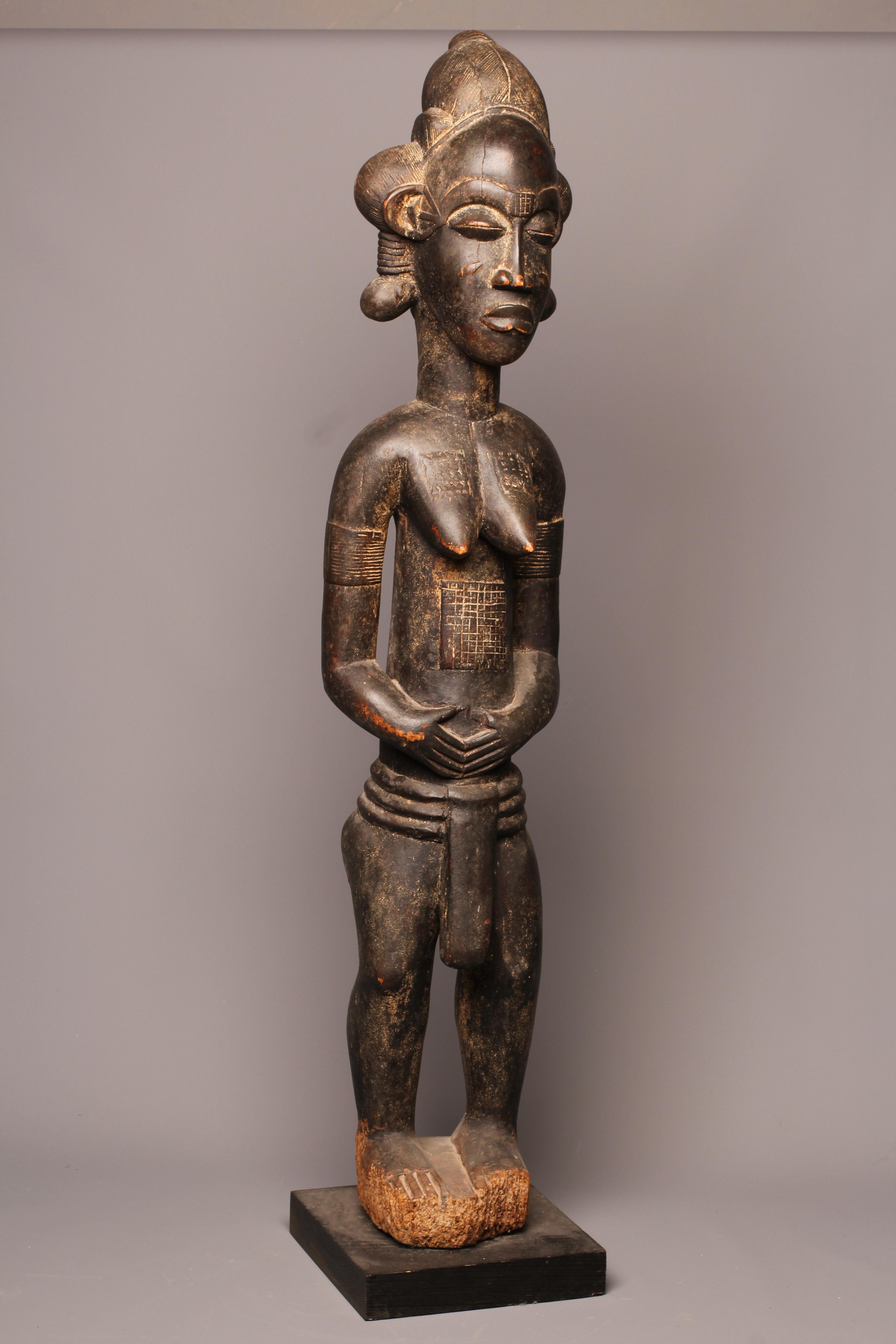 A BAULE FERTILITY FIGURE, Ivory Coast, carved with keloid scars to the head, chest and abdomen, Image