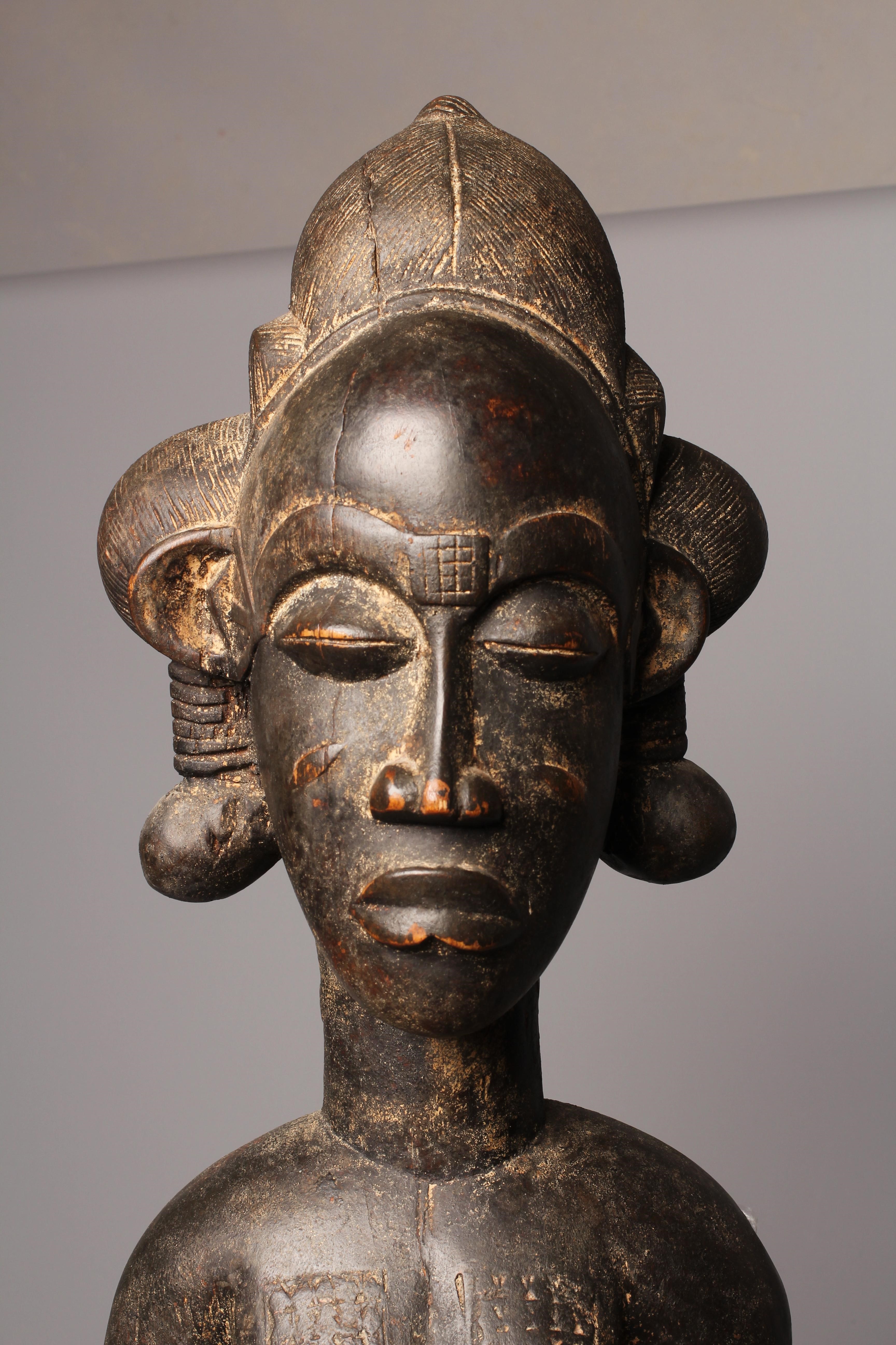 A BAULE FERTILITY FIGURE, Ivory Coast, carved with keloid scars to the head, chest and abdomen, Image
