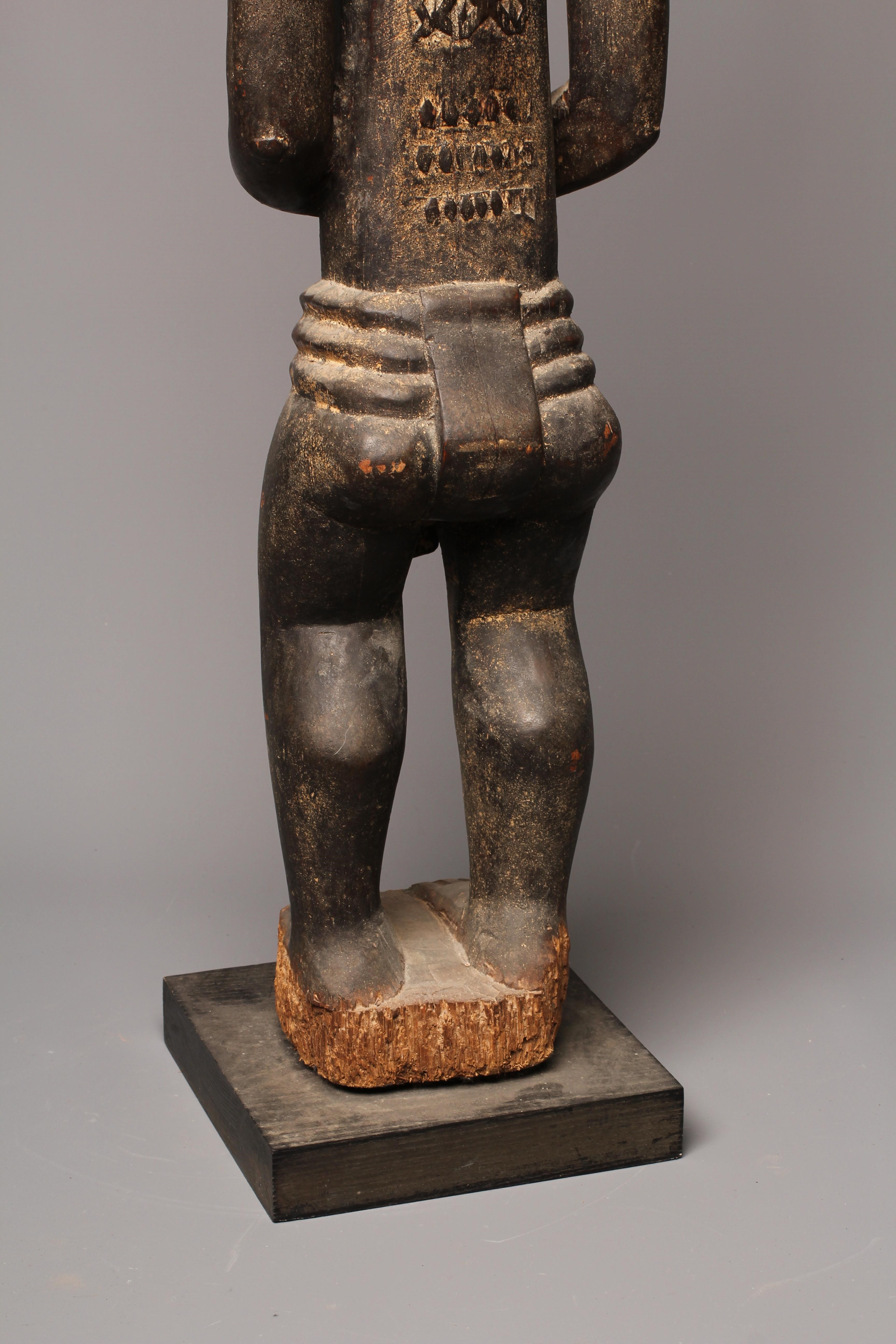 A BAULE FERTILITY FIGURE, Ivory Coast, carved with keloid scars to the head, chest and abdomen, Image