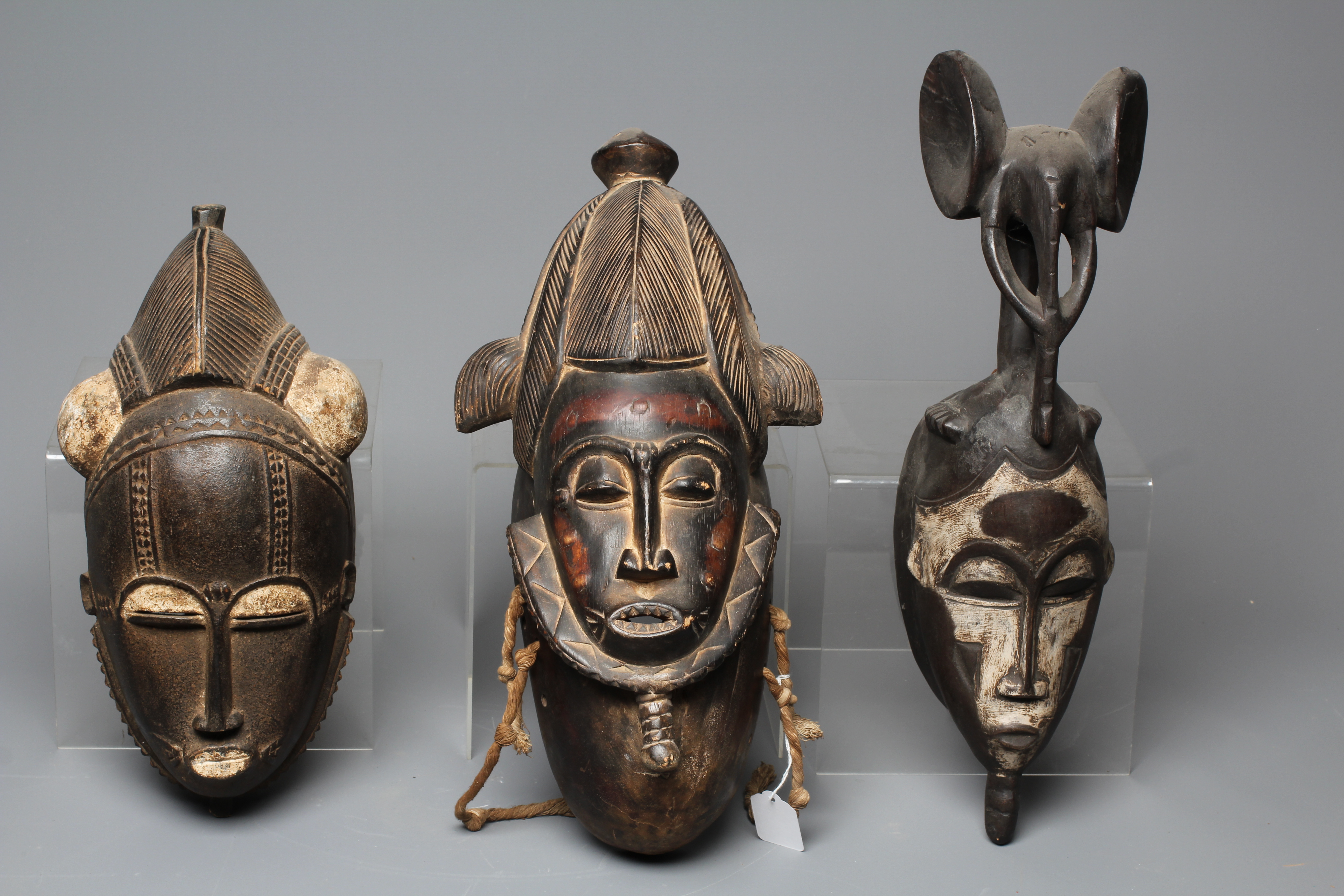 THREE BAULE CARVED WOOD MASKS, Ivory Coast, the largest 17" high Image