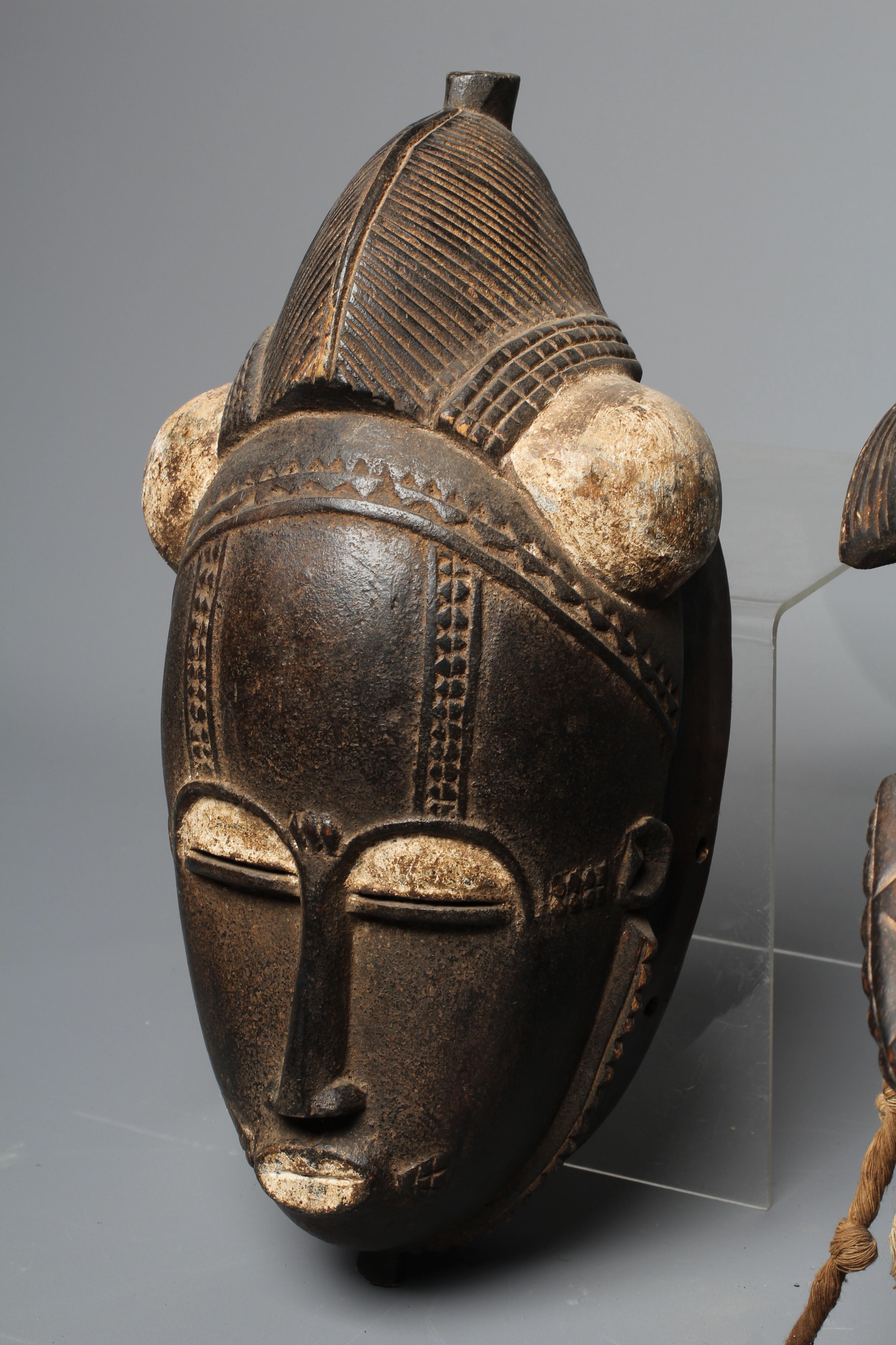 THREE BAULE CARVED WOOD MASKS, Ivory Coast, the largest 17" high Image