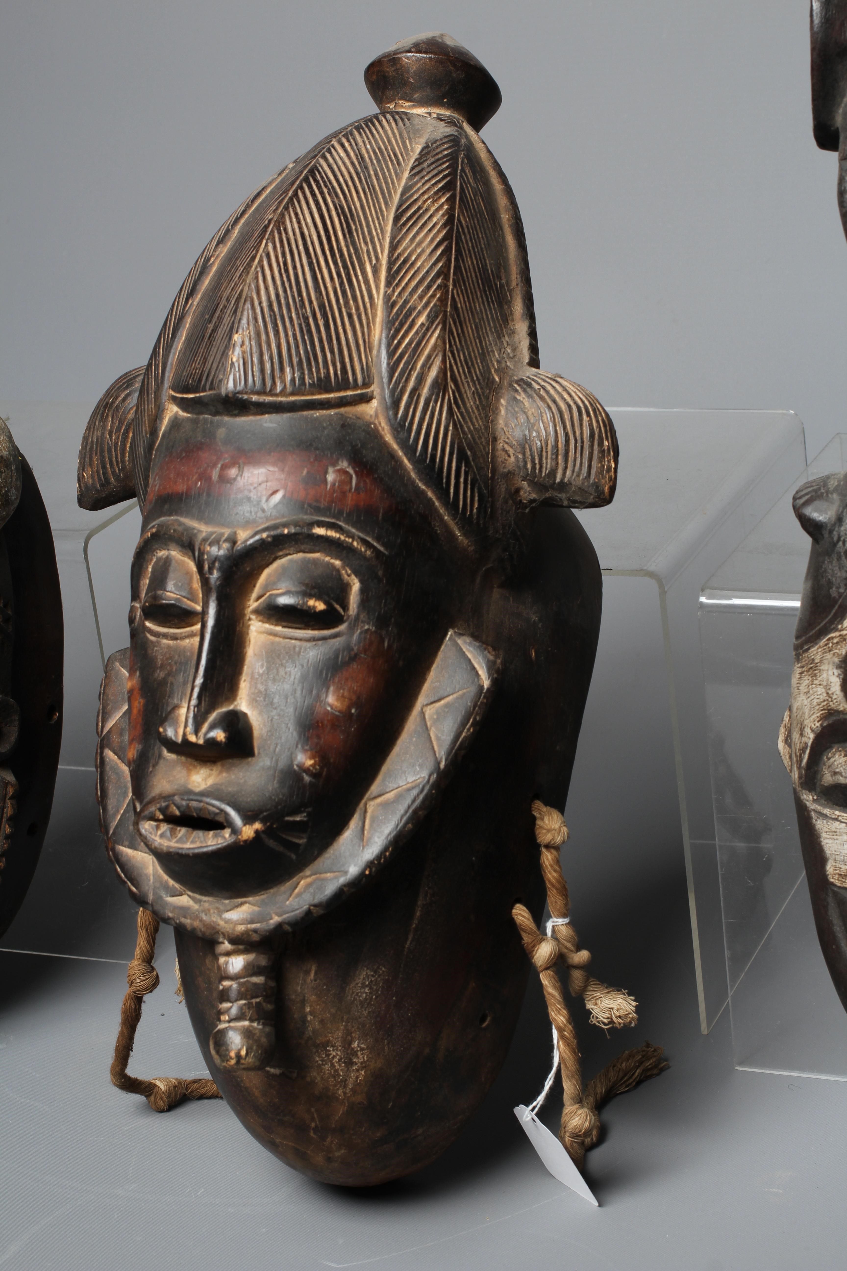 THREE BAULE CARVED WOOD MASKS, Ivory Coast, the largest 17" high Image