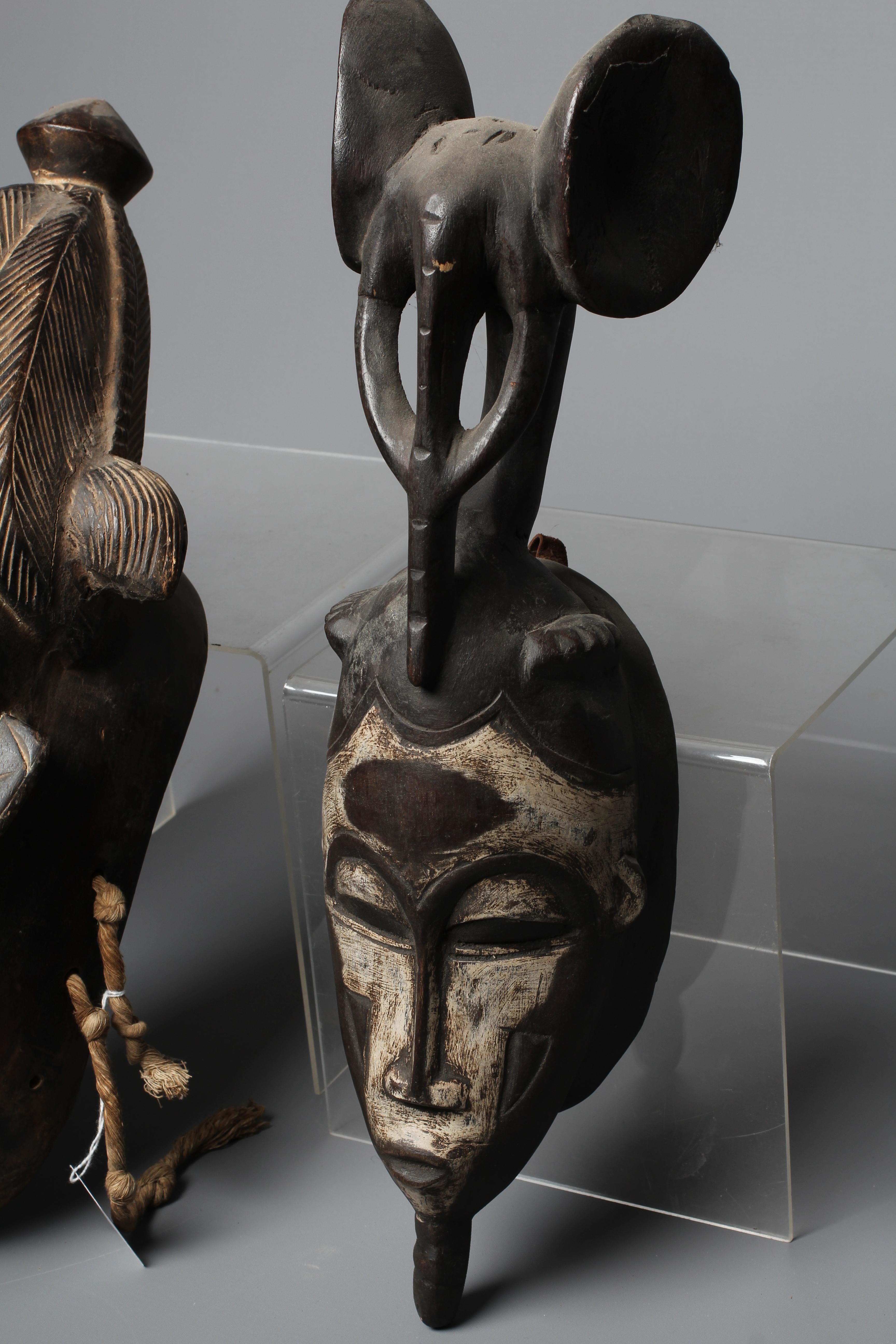 THREE BAULE CARVED WOOD MASKS, Ivory Coast, the largest 17" high Image