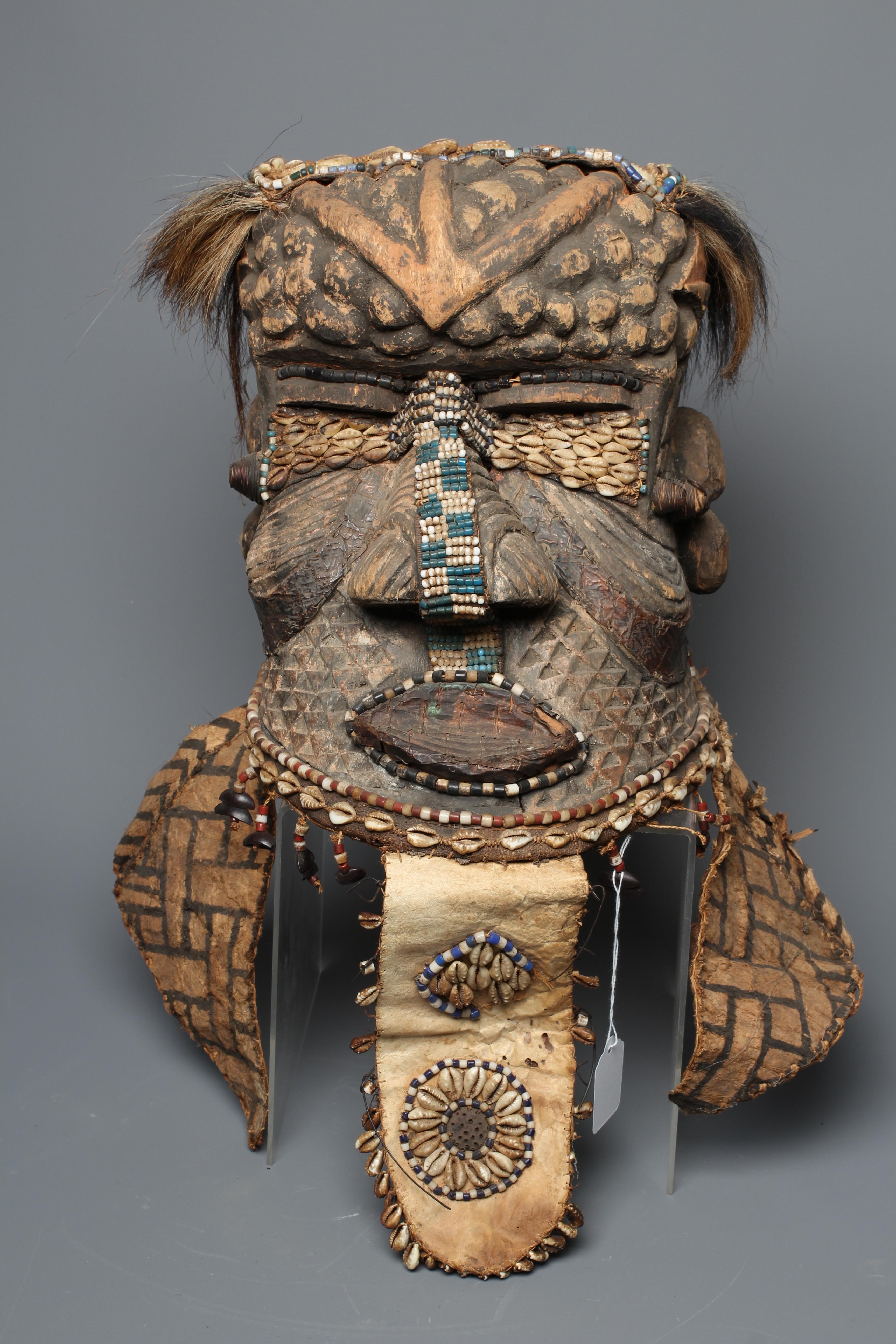 A KUBA BWOOM MASK, Congo, wood, hide, cloth and hair, with shell and bead decoration, 12" high Image