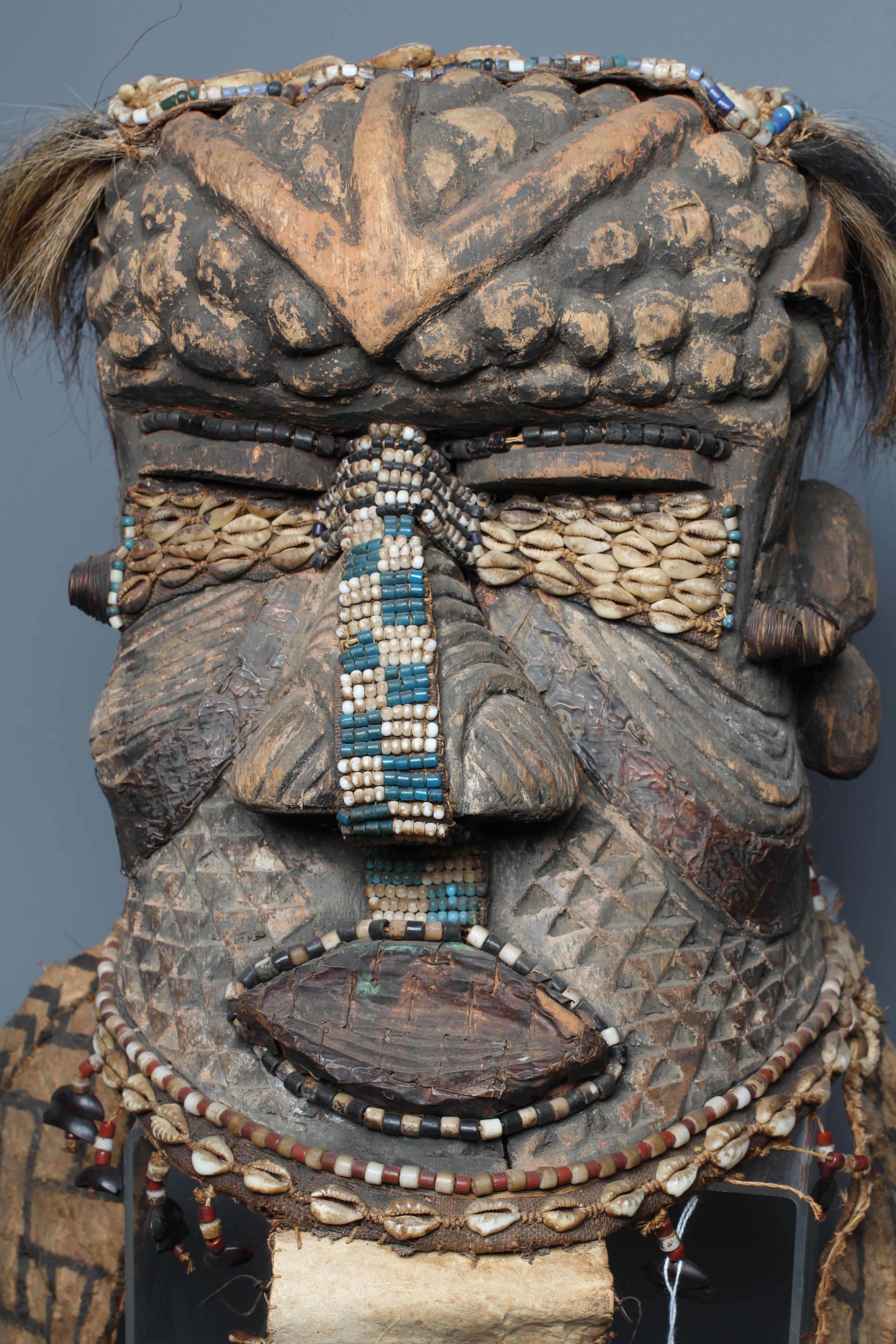 A KUBA BWOOM MASK, Congo, wood, hide, cloth and hair, with shell and bead decoration, 12" high Image