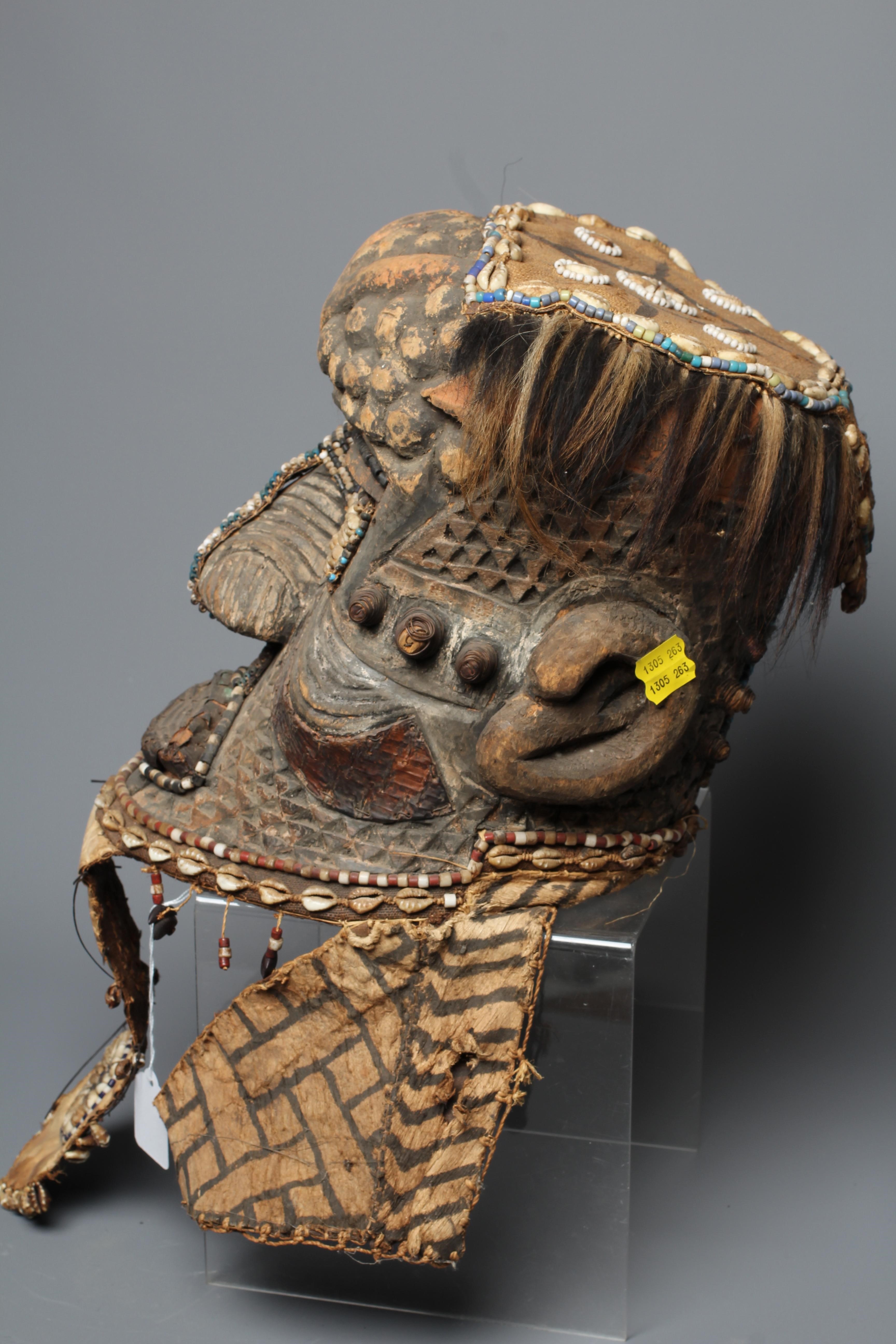 A KUBA BWOOM MASK, Congo, wood, hide, cloth and hair, with shell and bead decoration, 12" high Image