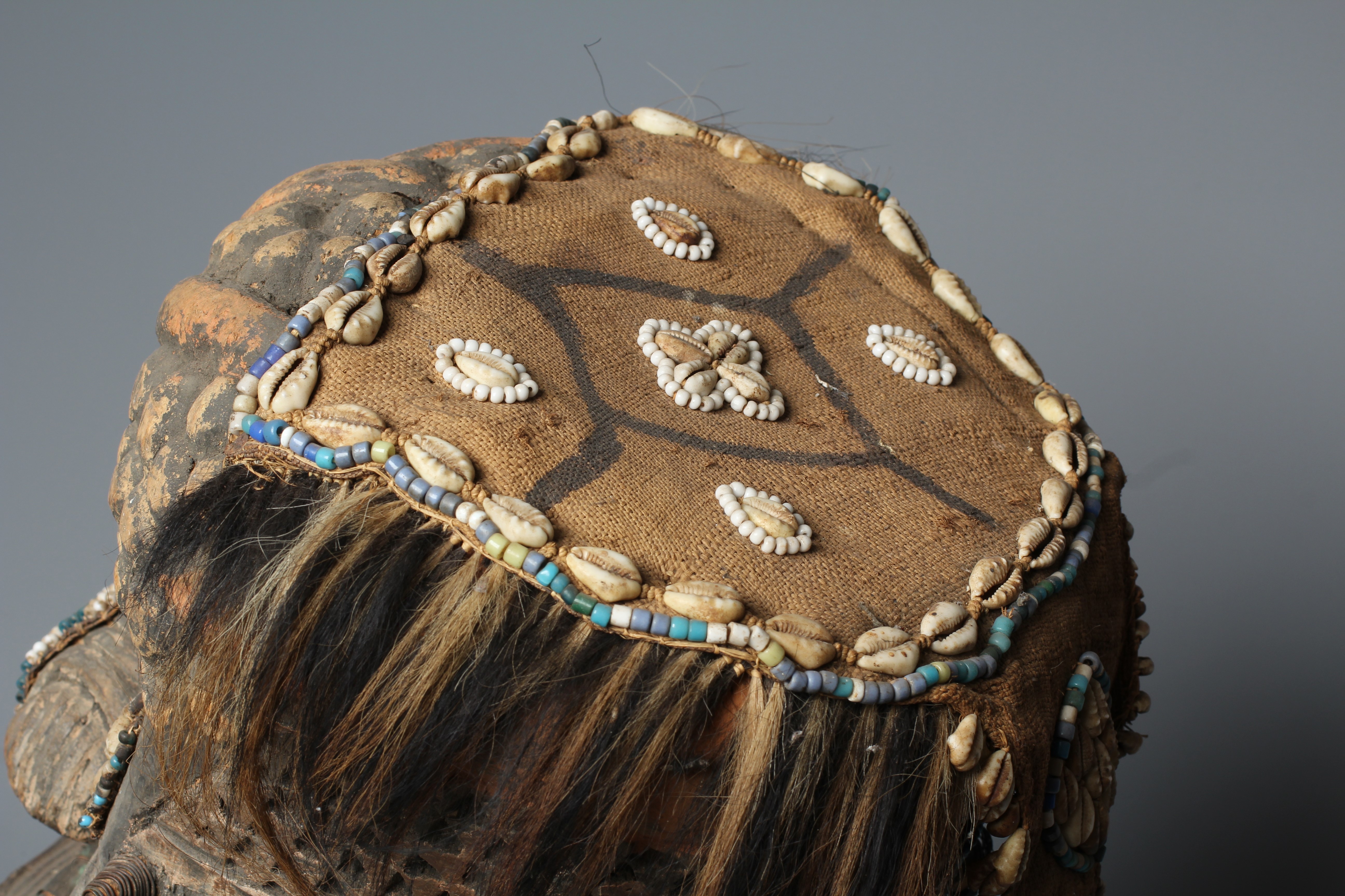 A KUBA BWOOM MASK, Congo, wood, hide, cloth and hair, with shell and bead decoration, 12" high Image