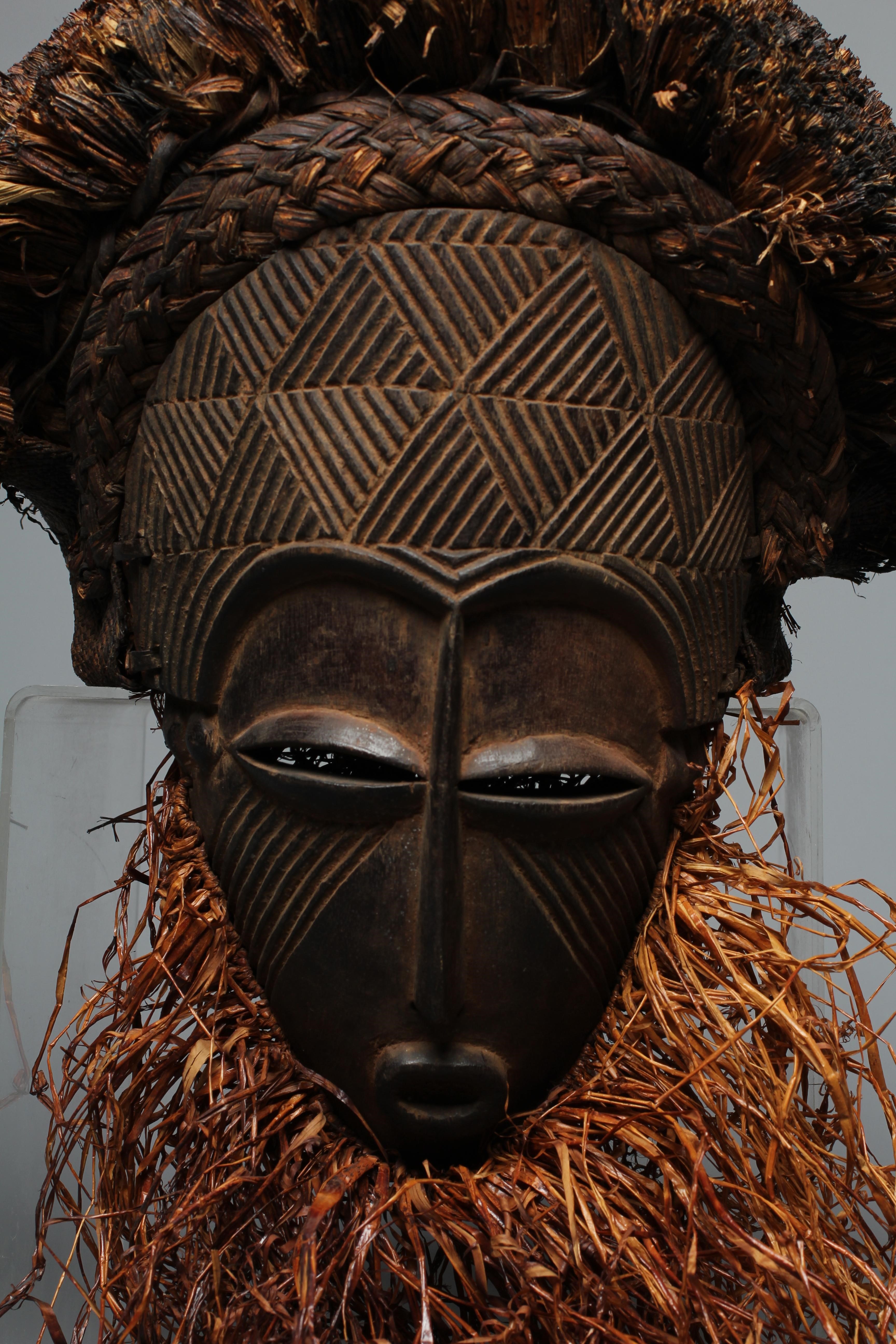 A CHOKWE OVAL MASK, Angola/Congo, with fibre hair and beard and geometric decoration in relief to Image