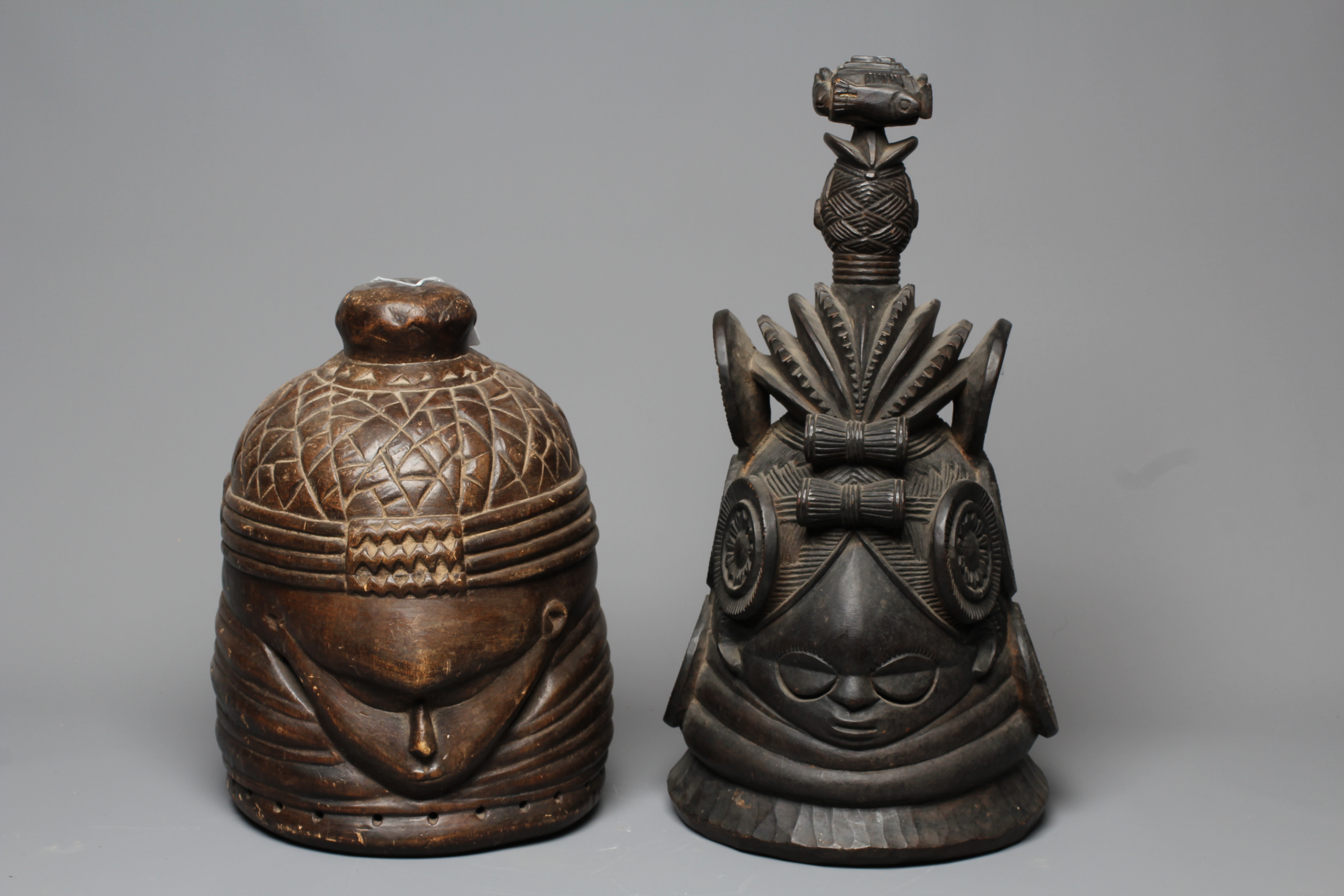 A MENDE HELMET MASK, Sierra Leone, heavily carved wood, 13 1/2", together with another Mende helmet Image