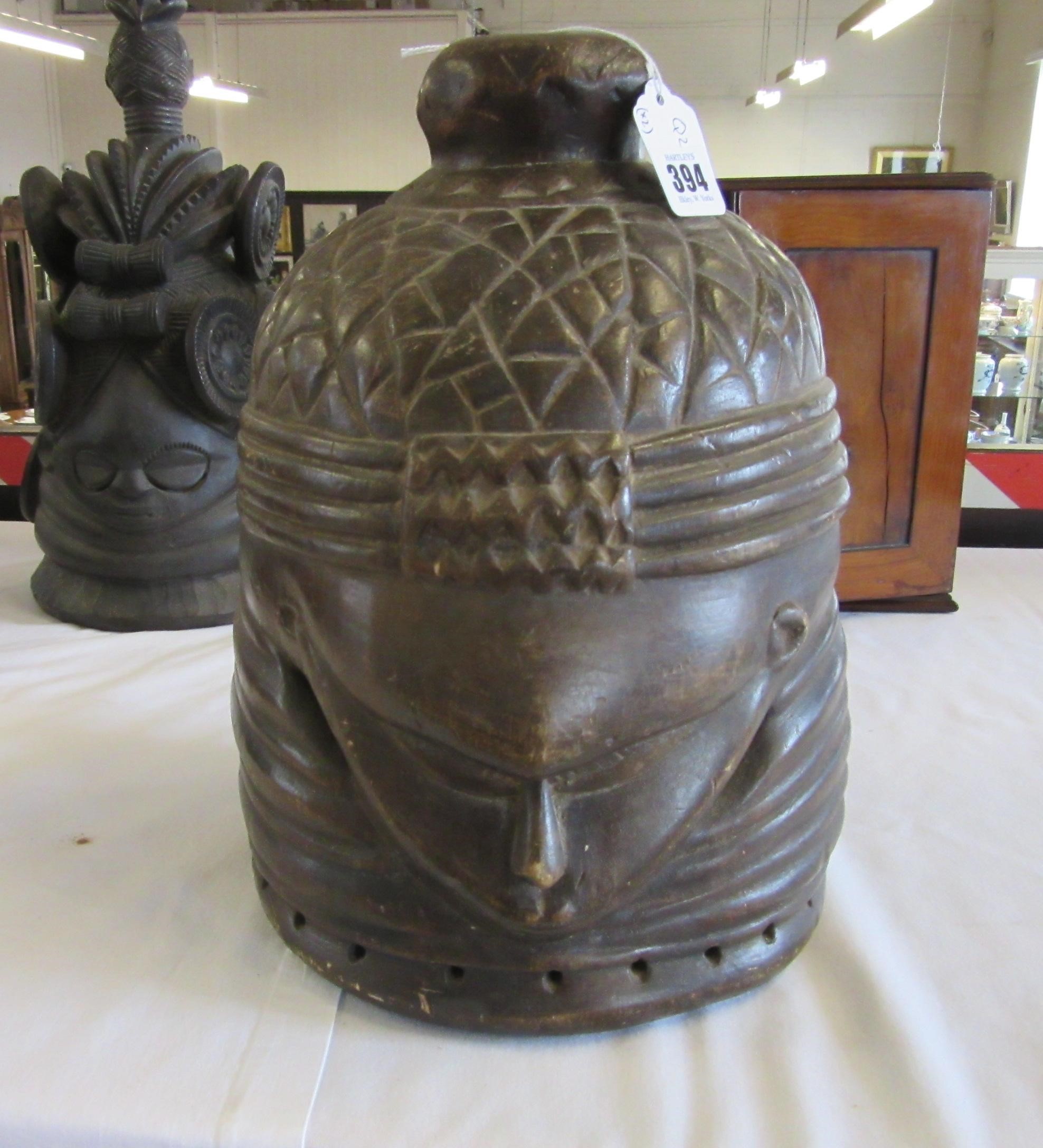 A MENDE HELMET MASK, Sierra Leone, heavily carved wood, 13 1/2", together with another Mende helmet Image