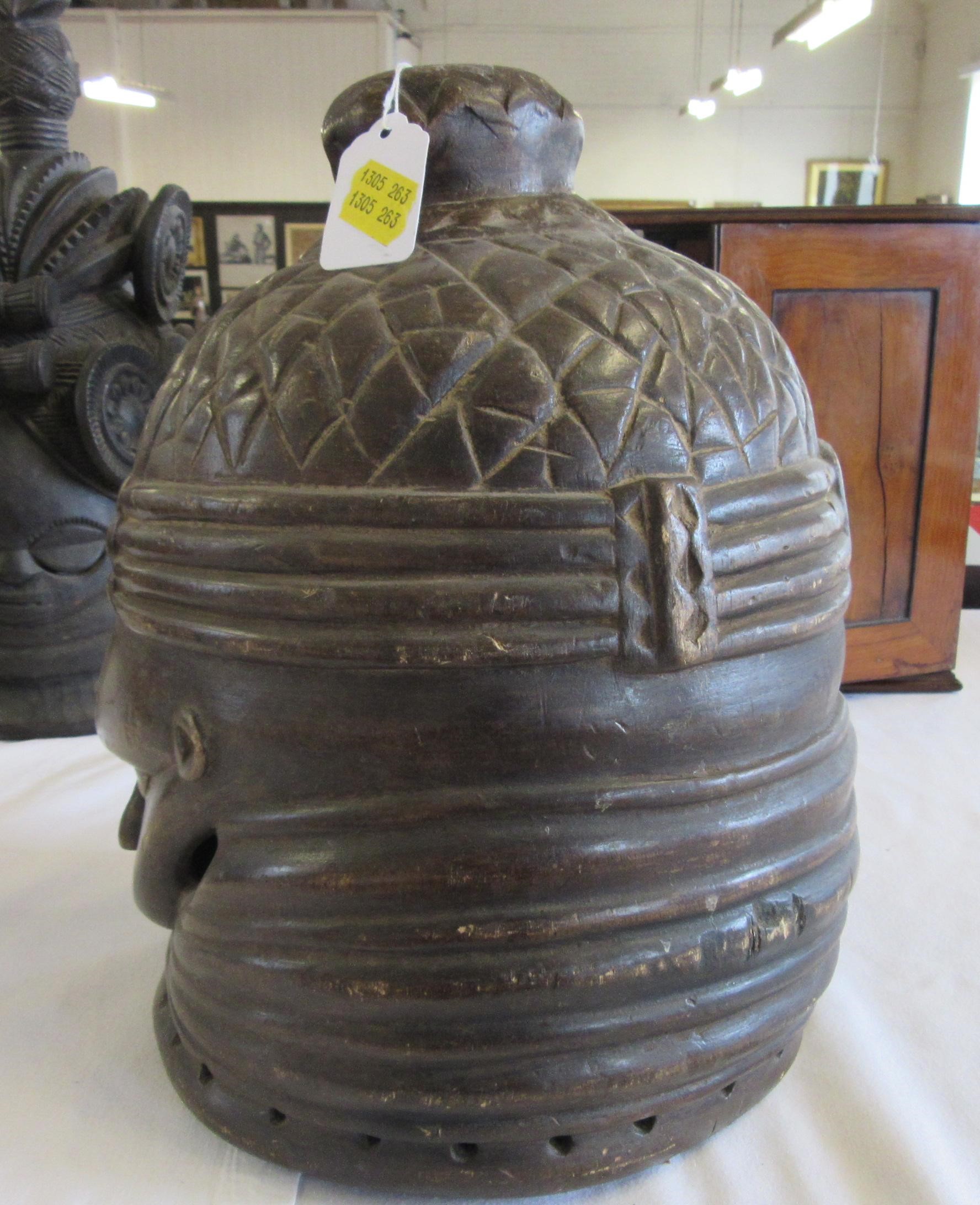 A MENDE HELMET MASK, Sierra Leone, heavily carved wood, 13 1/2", together with another Mende helmet Image