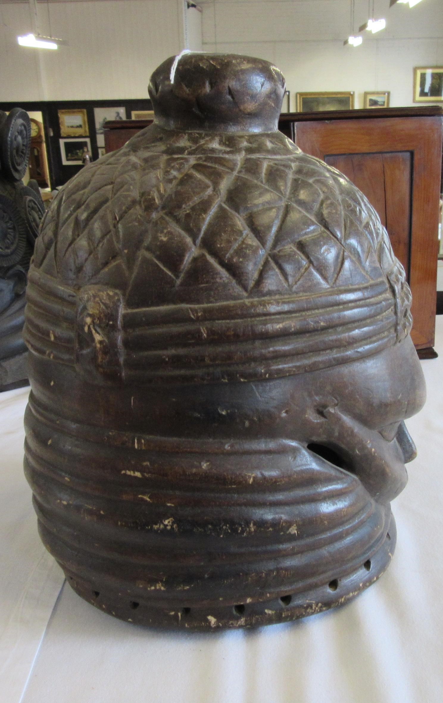 A MENDE HELMET MASK, Sierra Leone, heavily carved wood, 13 1/2", together with another Mende helmet Image