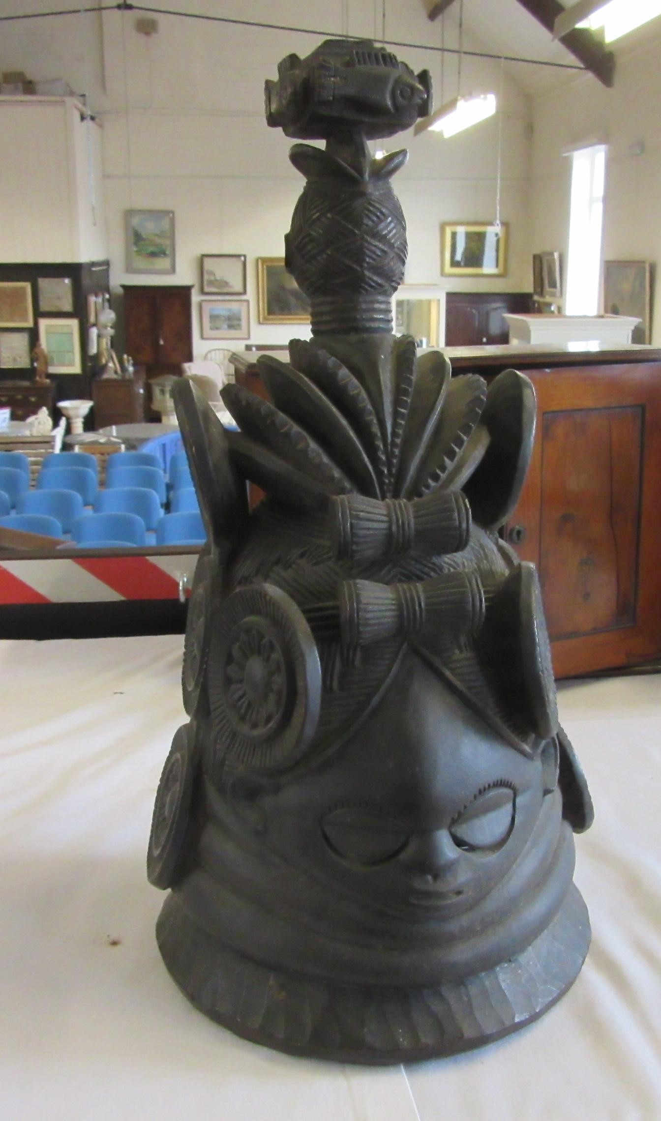A MENDE HELMET MASK, Sierra Leone, heavily carved wood, 13 1/2", together with another Mende helmet Image