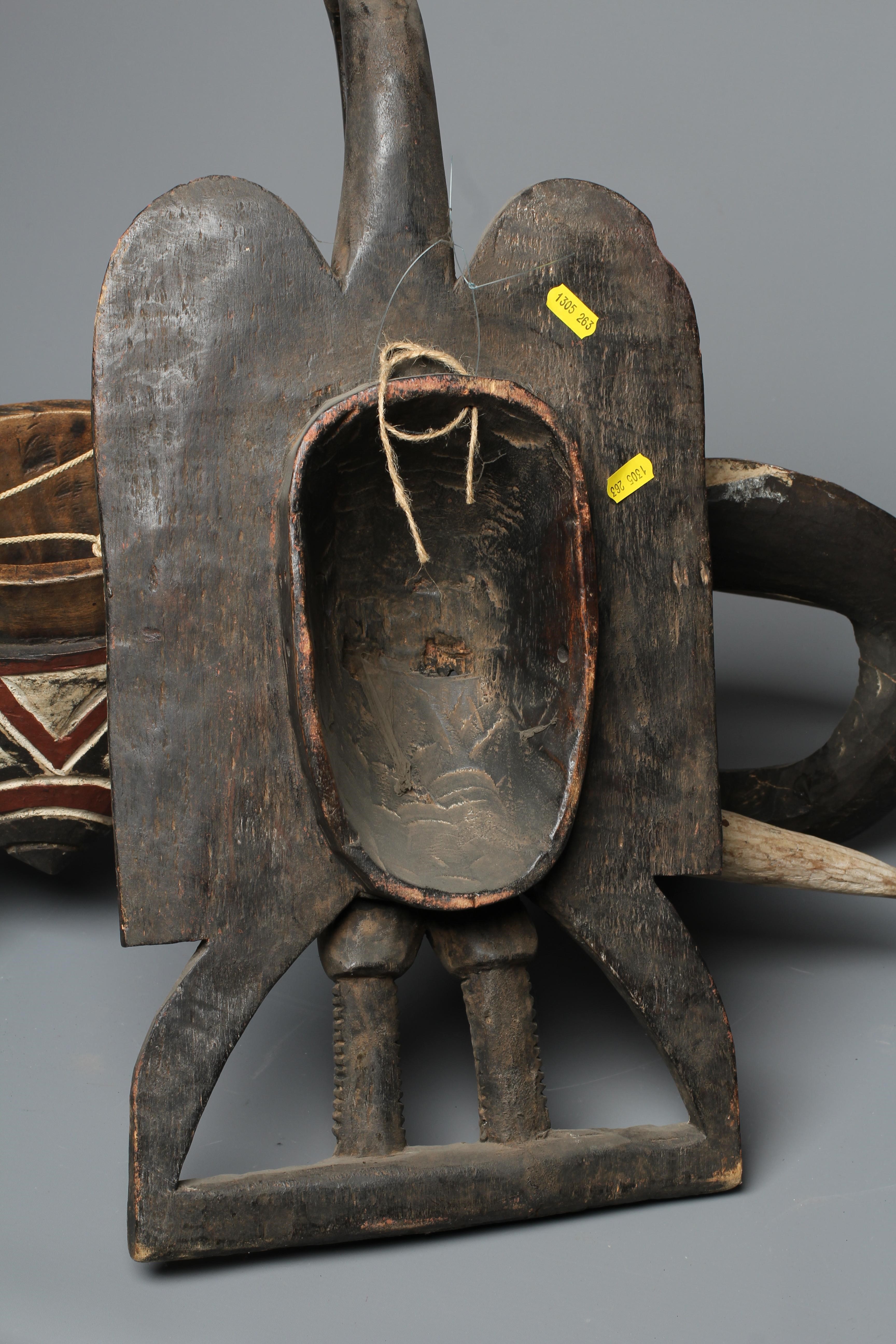 A CENTRAL AFRICAN CARVED WOOD ELEPHANT MASK, hand painted with shaped curved trunk, alert ears and Image