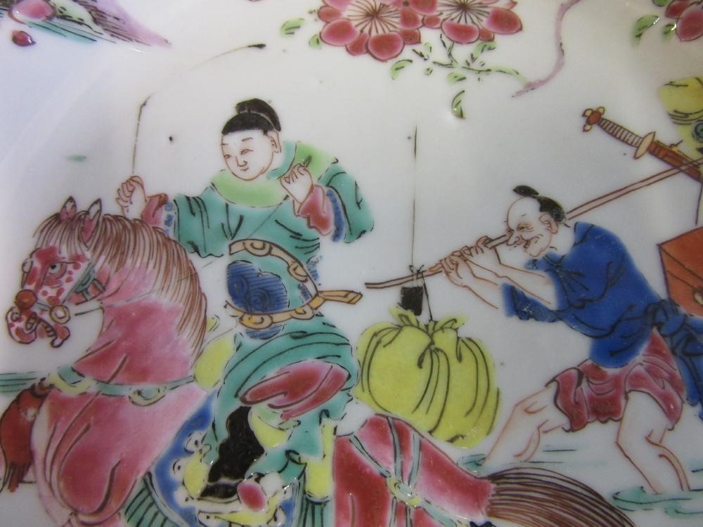 FOUR CHINESE FAMILLE ROSE PORCELAIN PLATES comprising a saucer dish with figures and dogs on a Image