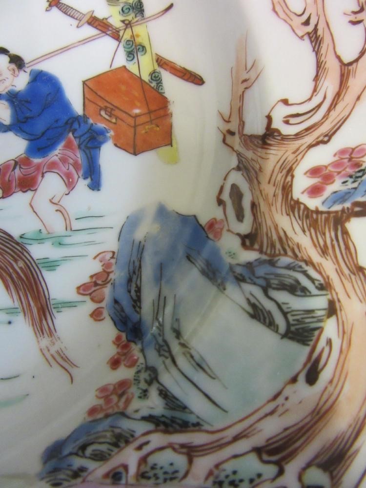 FOUR CHINESE FAMILLE ROSE PORCELAIN PLATES comprising a saucer dish with figures and dogs on a Image