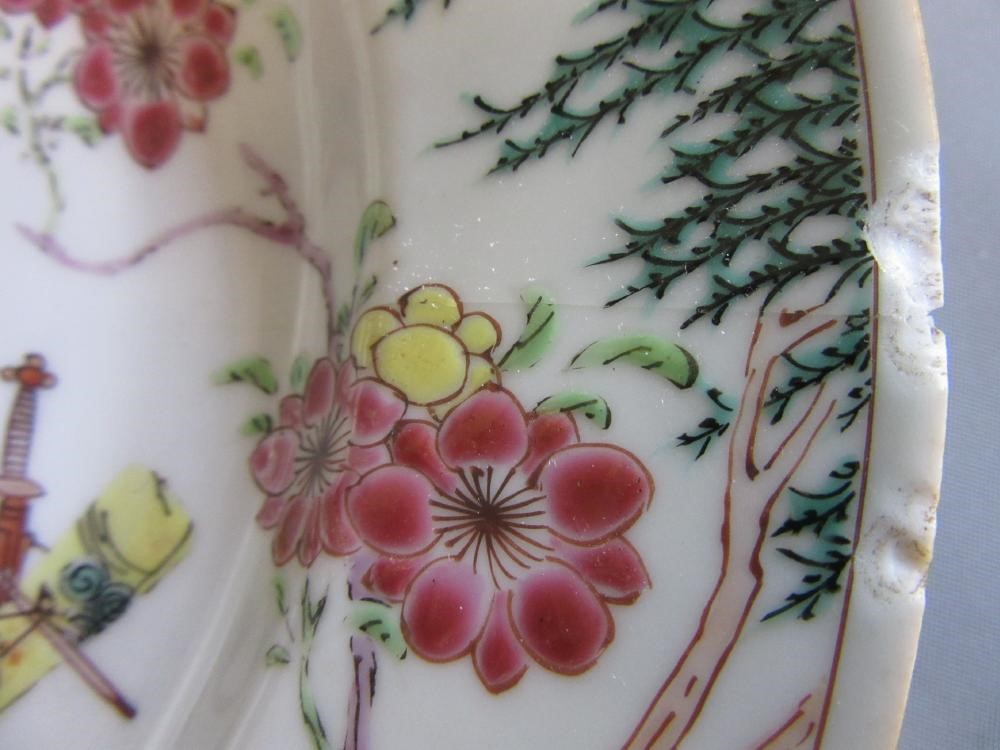 FOUR CHINESE FAMILLE ROSE PORCELAIN PLATES comprising a saucer dish with figures and dogs on a Image