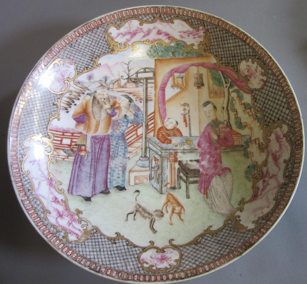 FOUR CHINESE FAMILLE ROSE PORCELAIN PLATES comprising a saucer dish with figures and dogs on a Image