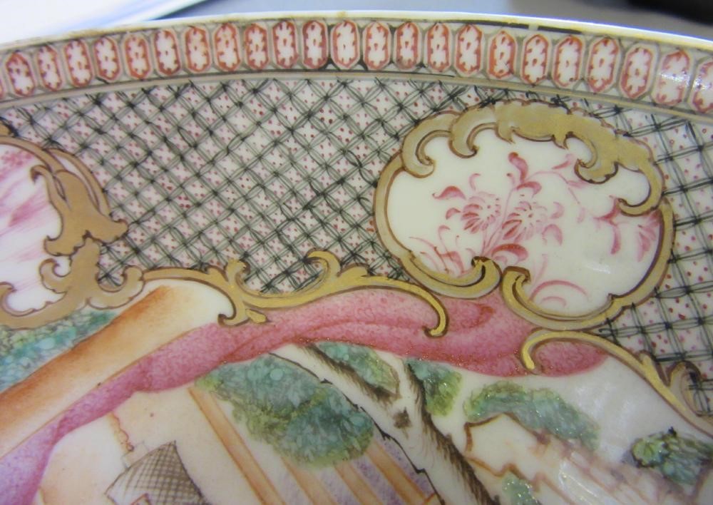 FOUR CHINESE FAMILLE ROSE PORCELAIN PLATES comprising a saucer dish with figures and dogs on a Image