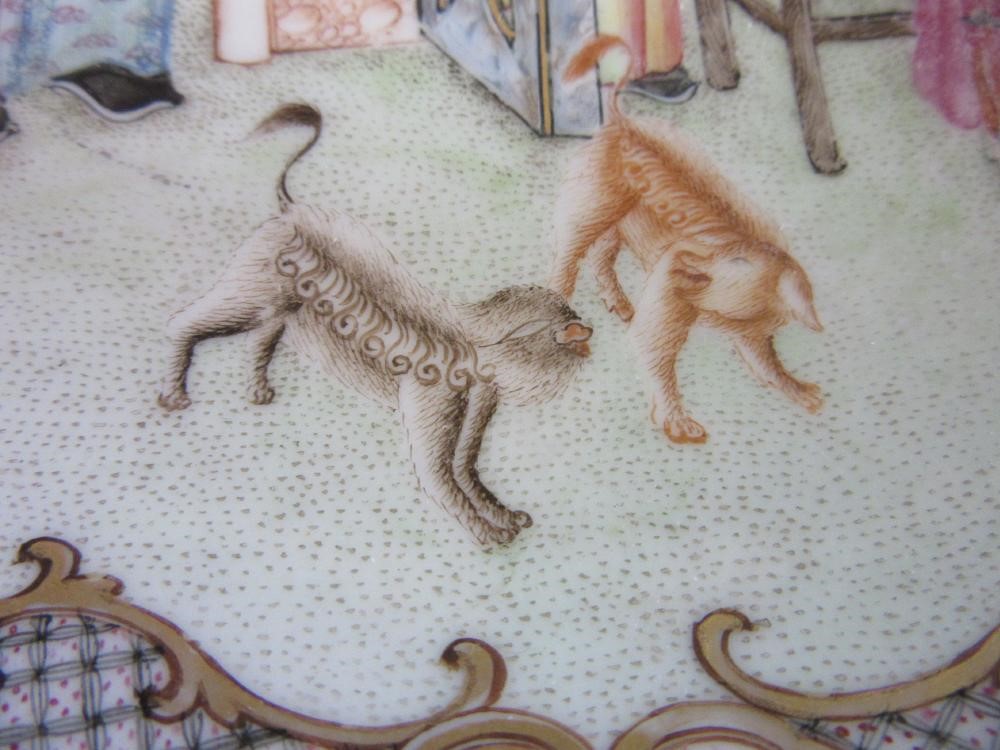 FOUR CHINESE FAMILLE ROSE PORCELAIN PLATES comprising a saucer dish with figures and dogs on a Image
