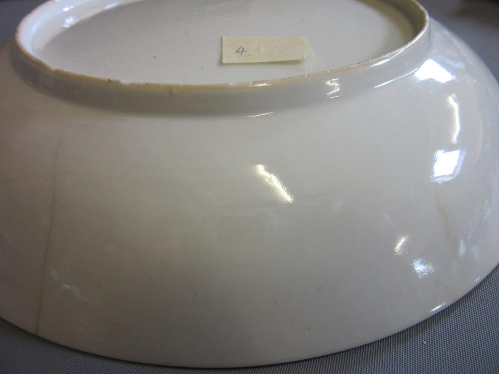 FOUR CHINESE FAMILLE ROSE PORCELAIN PLATES comprising a saucer dish with figures and dogs on a Image