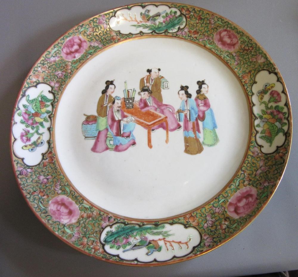 FOUR CHINESE FAMILLE ROSE PORCELAIN PLATES comprising a saucer dish with figures and dogs on a Image