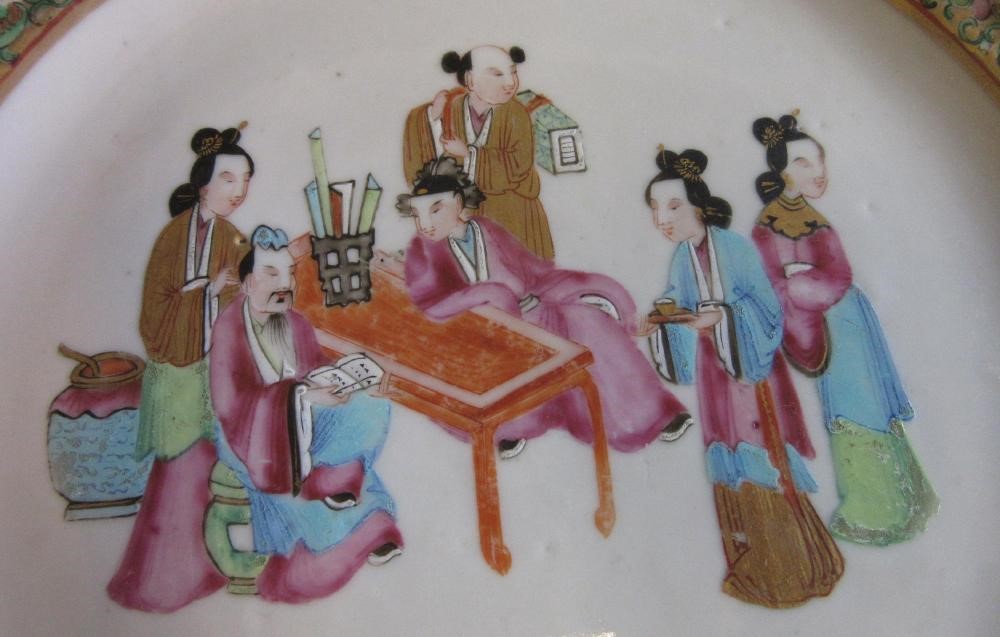 FOUR CHINESE FAMILLE ROSE PORCELAIN PLATES comprising a saucer dish with figures and dogs on a Image