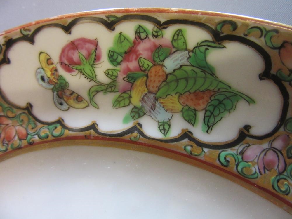 FOUR CHINESE FAMILLE ROSE PORCELAIN PLATES comprising a saucer dish with figures and dogs on a Image