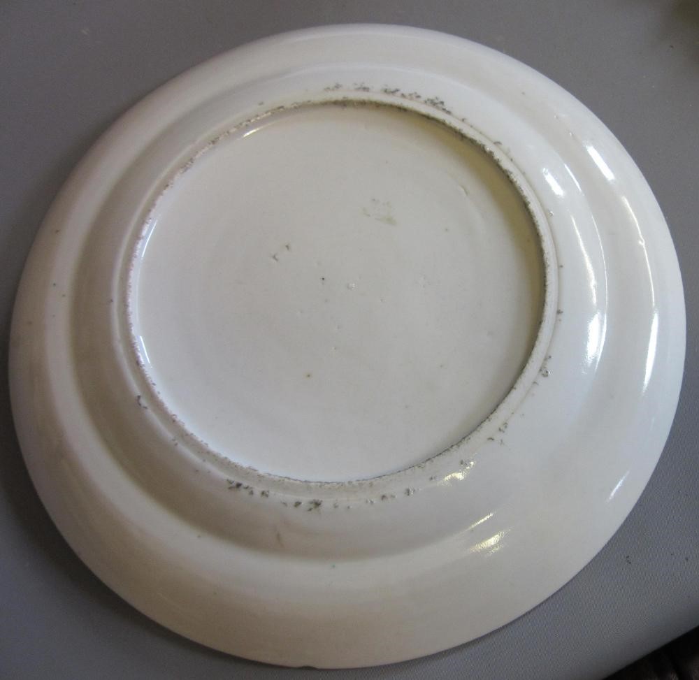 FOUR CHINESE FAMILLE ROSE PORCELAIN PLATES comprising a saucer dish with figures and dogs on a Image