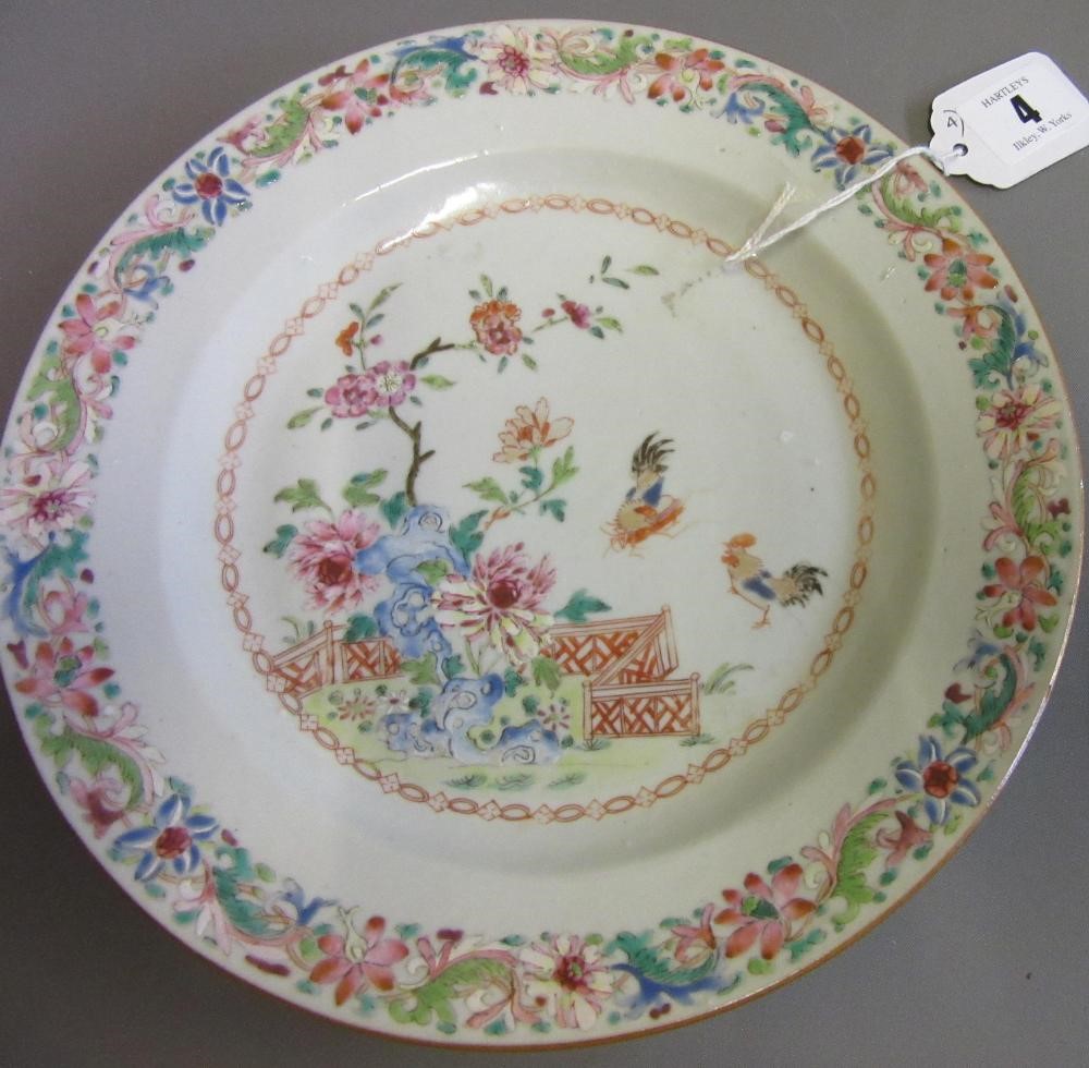 FOUR CHINESE FAMILLE ROSE PORCELAIN PLATES comprising a saucer dish with figures and dogs on a Image