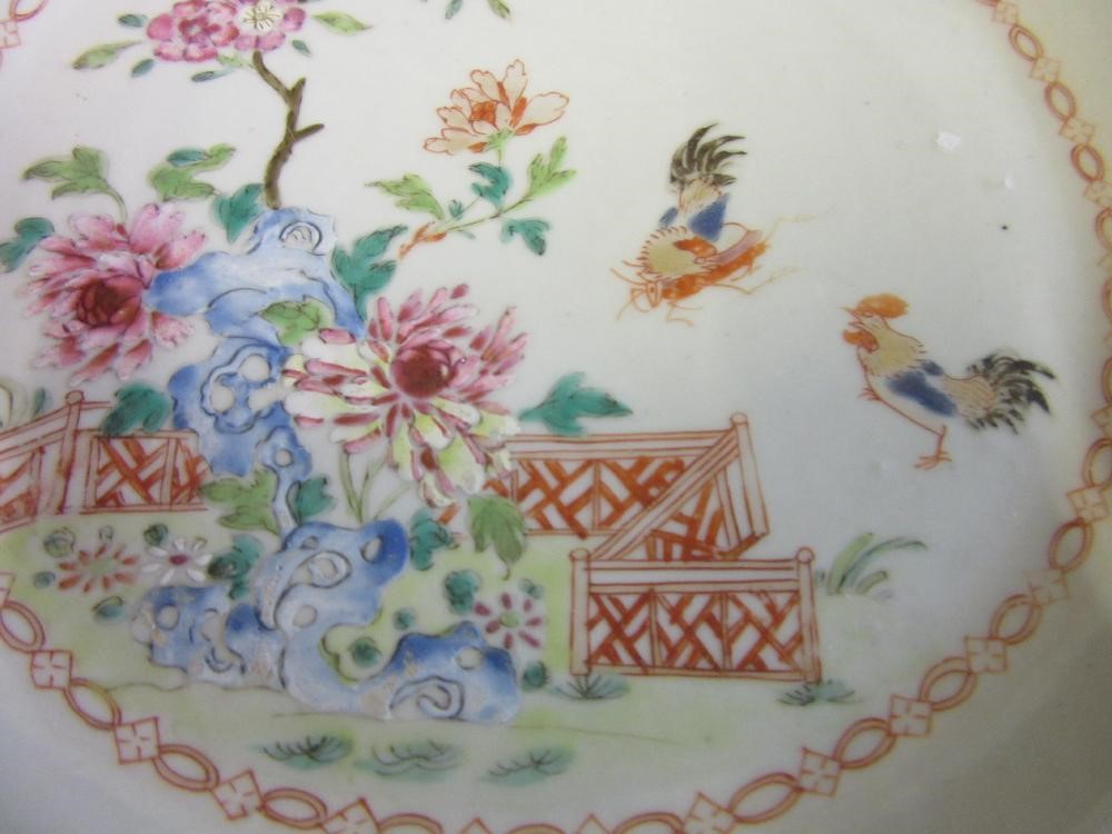 FOUR CHINESE FAMILLE ROSE PORCELAIN PLATES comprising a saucer dish with figures and dogs on a Image