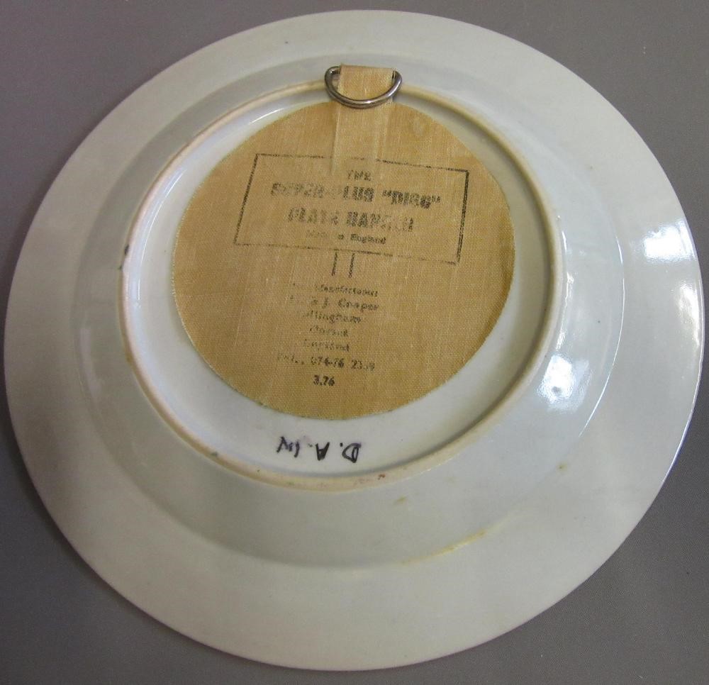 FOUR CHINESE FAMILLE ROSE PORCELAIN PLATES comprising a saucer dish with figures and dogs on a Image