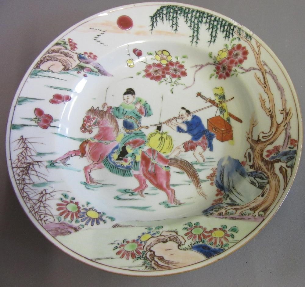 FOUR CHINESE FAMILLE ROSE PORCELAIN PLATES comprising a saucer dish with figures and dogs on a Image