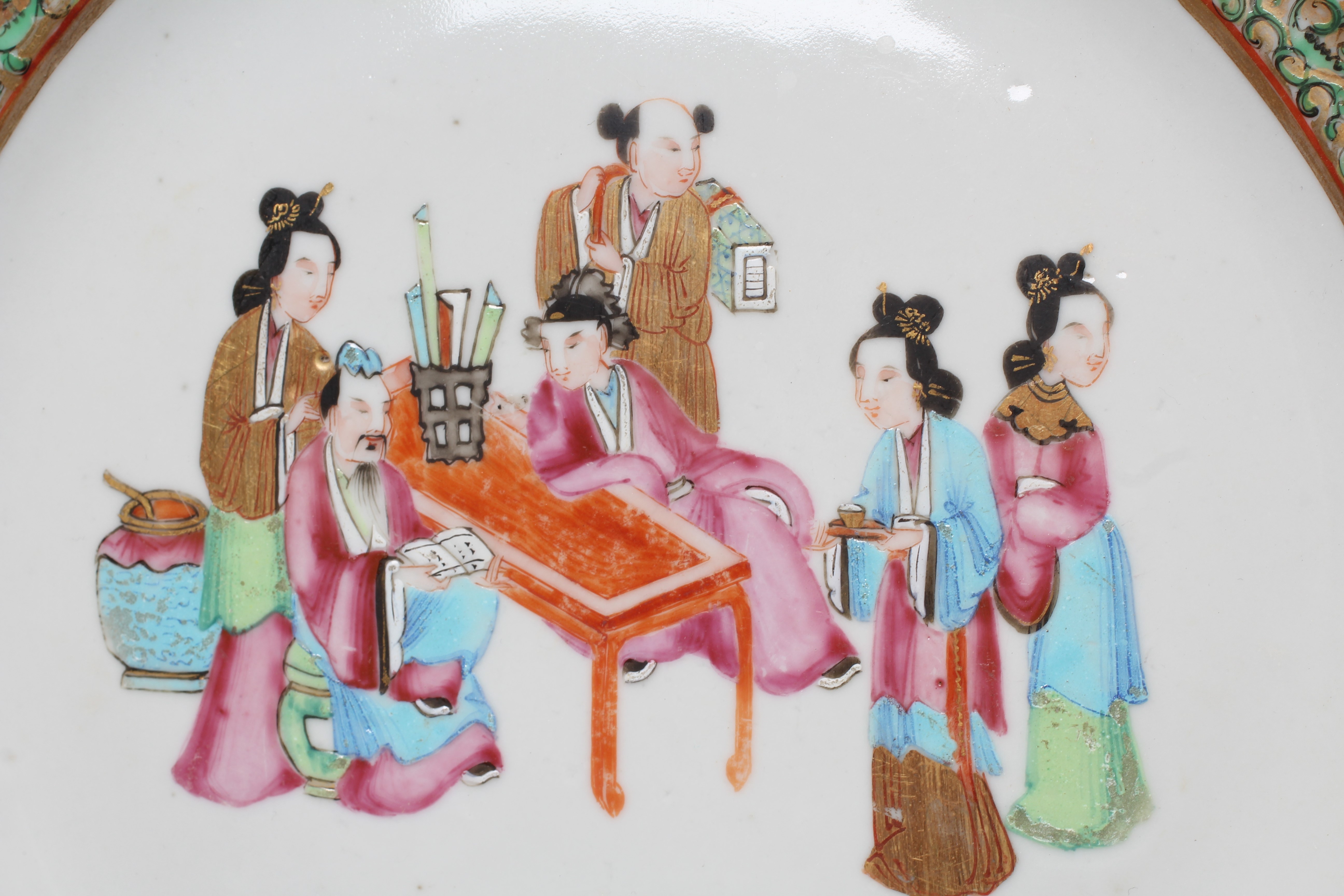 FOUR CHINESE FAMILLE ROSE PORCELAIN PLATES comprising a saucer dish with figures and dogs on a Image