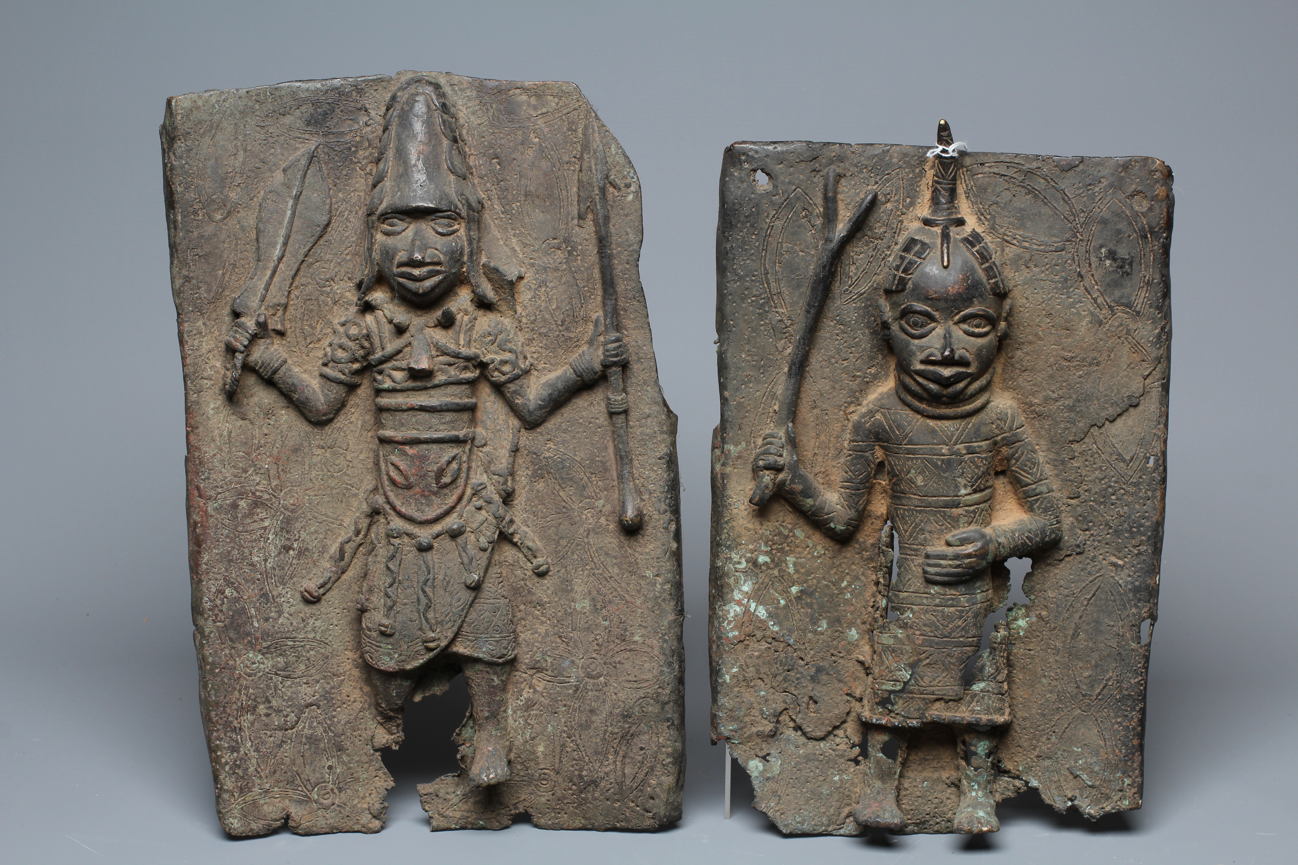 A PAIR OF BENIN BRONZE PLAQUES, each worked in relief with central warrior figure, 15 1/2" x 9 1/2" Image