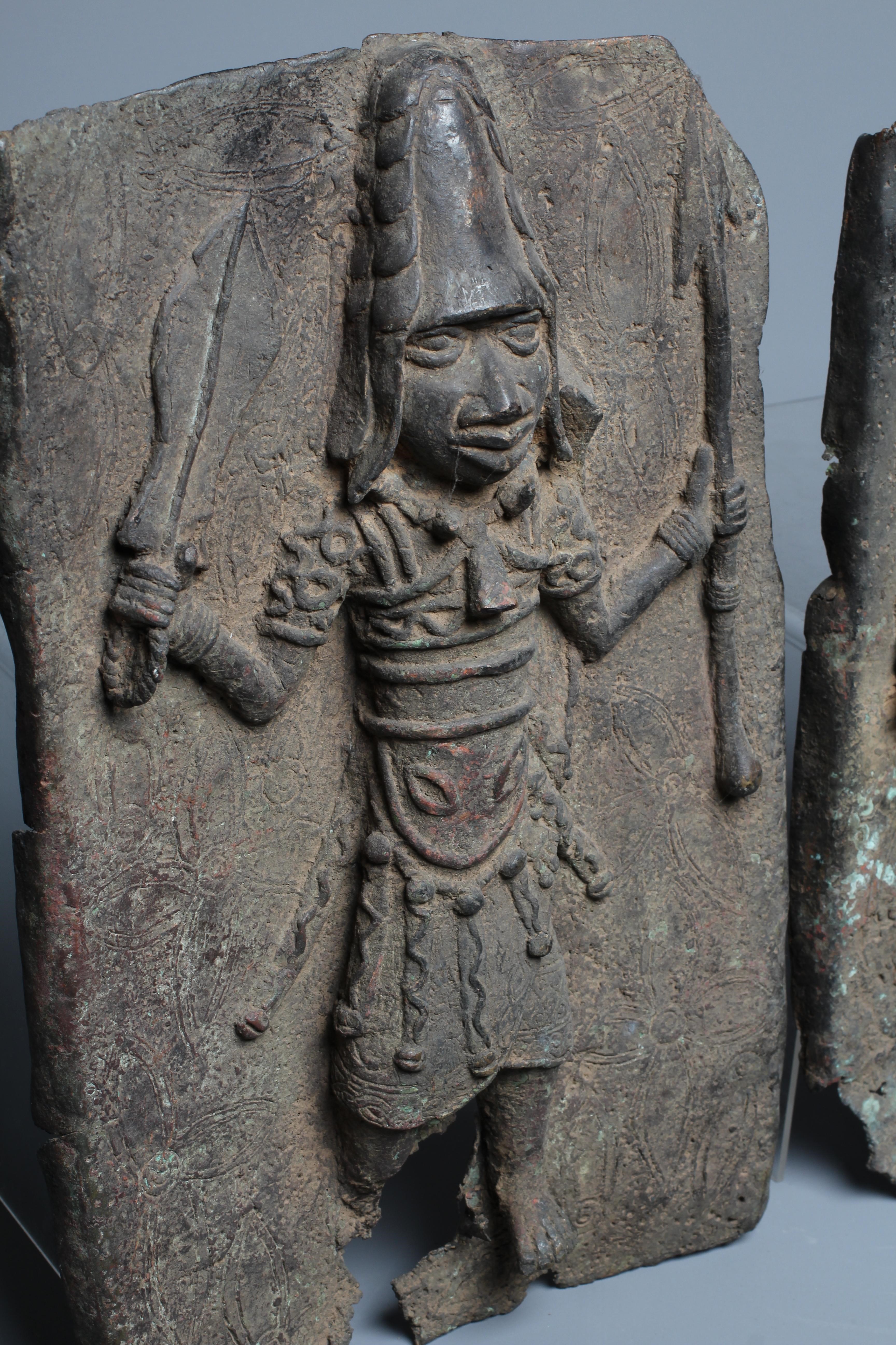 A PAIR OF BENIN BRONZE PLAQUES, each worked in relief with central warrior figure, 15 1/2" x 9 1/2" Image