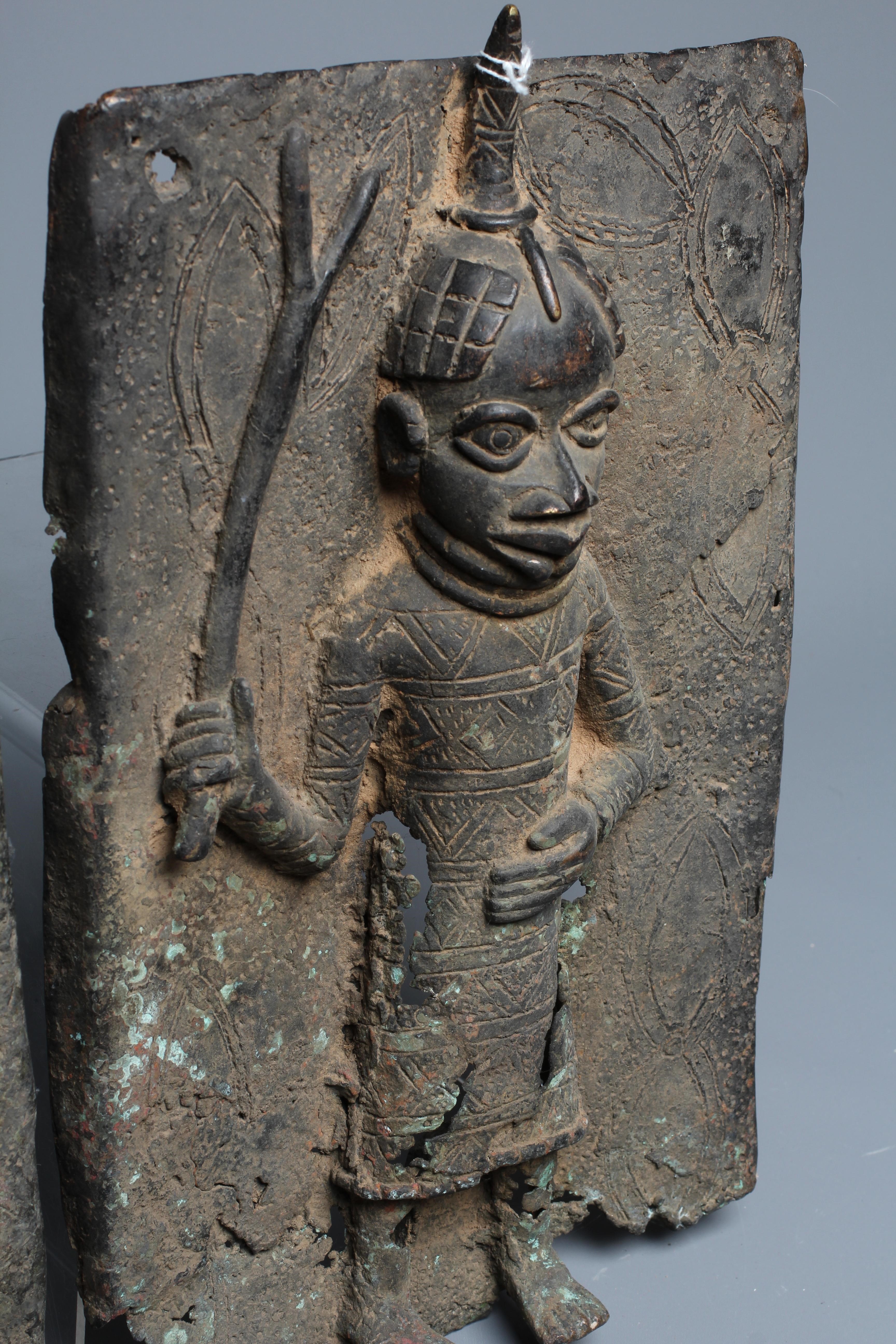 A PAIR OF BENIN BRONZE PLAQUES, each worked in relief with central warrior figure, 15 1/2" x 9 1/2" Image