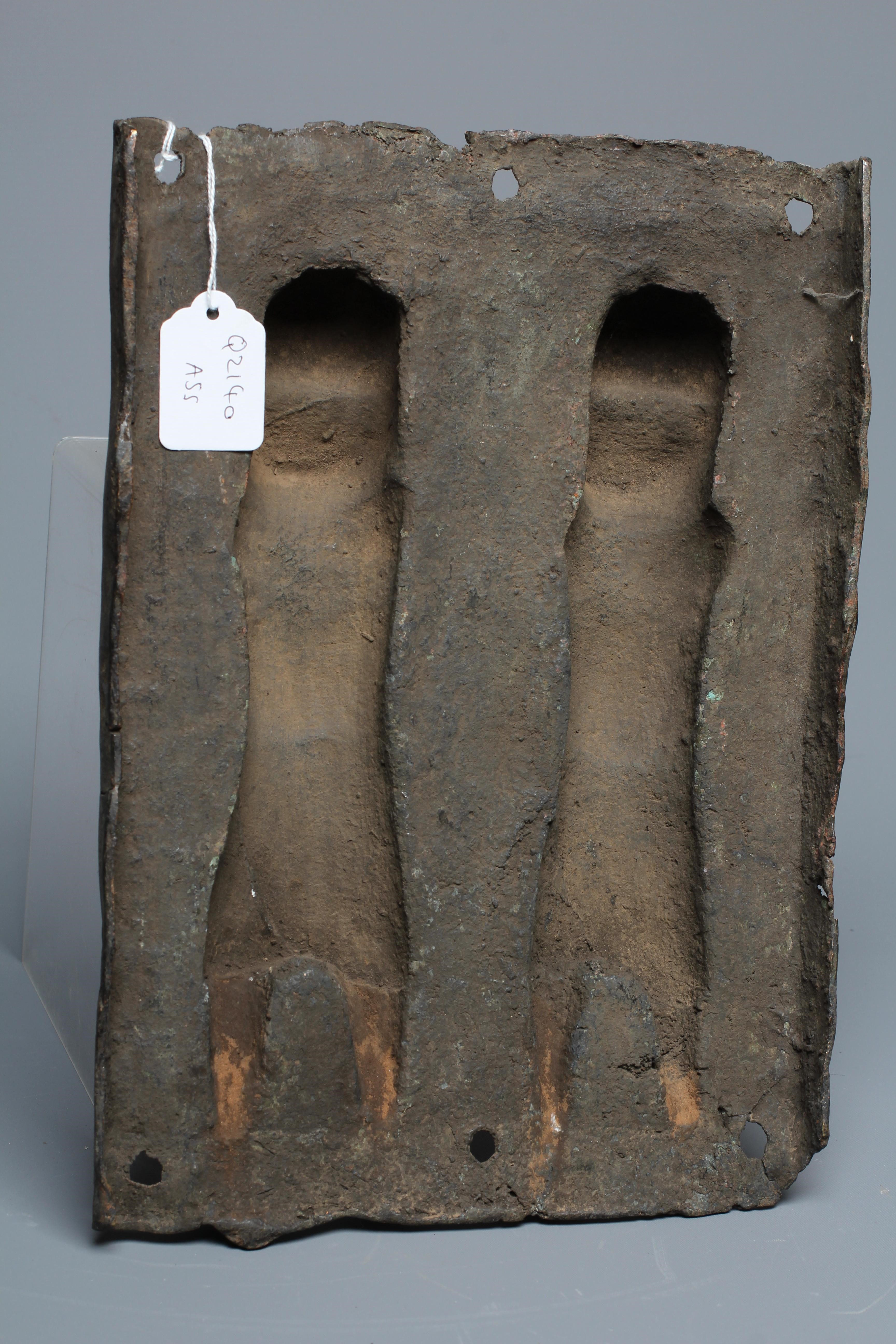 A BENIN BRONZE PLAQUE worked in relief with two standing warriors, 13" h x 9" w Image