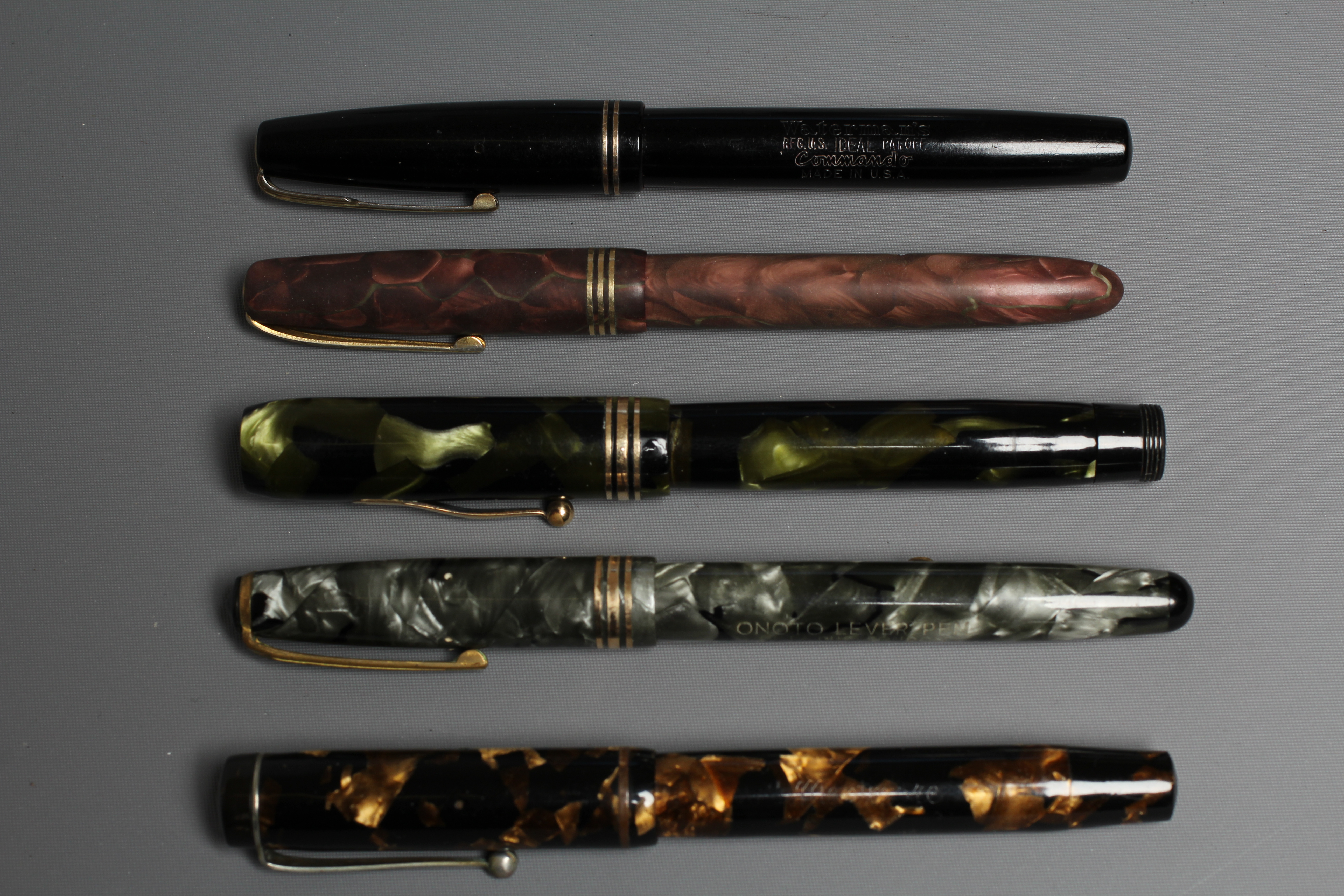 FIVE FOUNTAIN PENS: comprising a black Waterman's Ideal Commando lever filler pen marked 14kt Image
