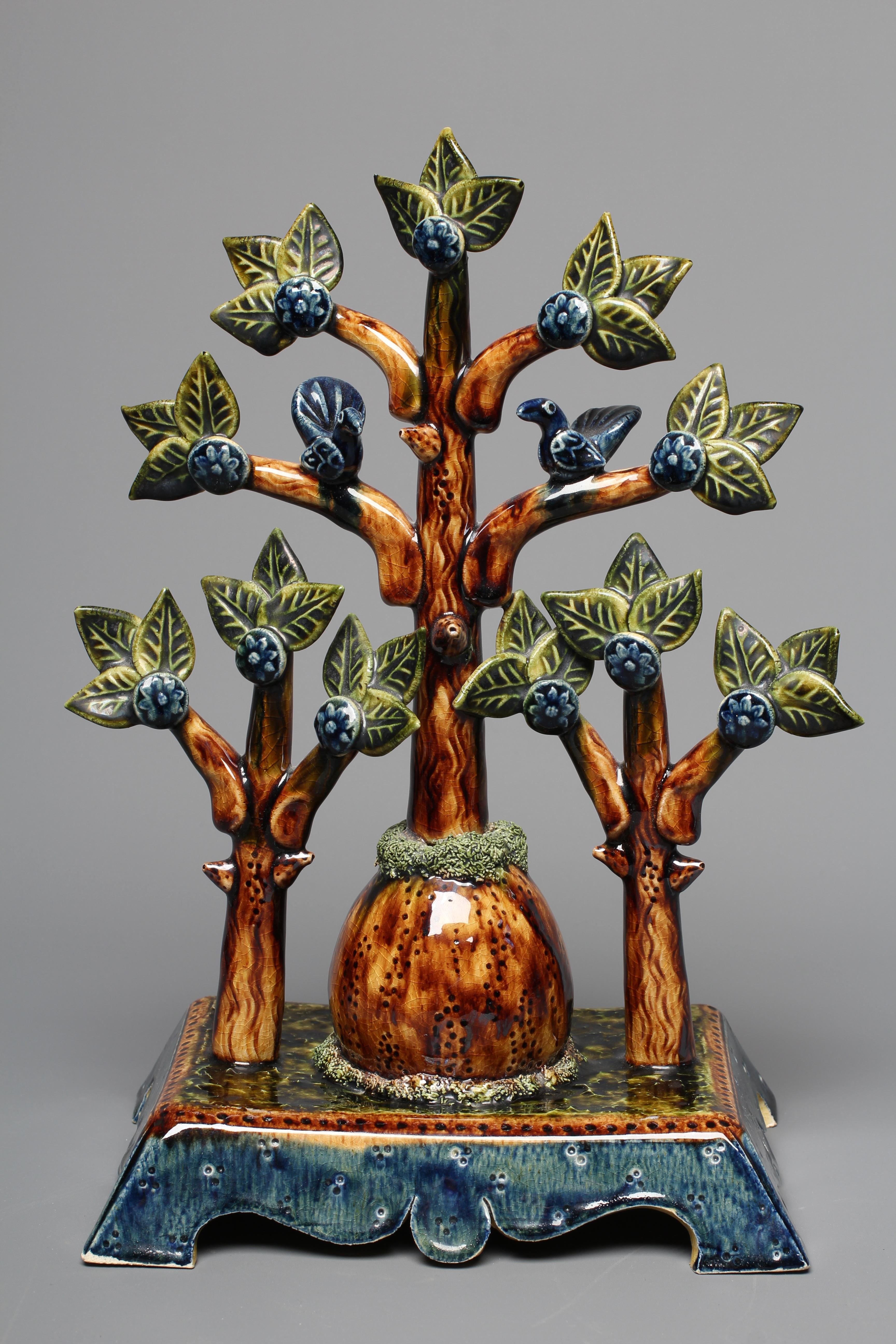 PAUL YOUNG (B.1961) A SLIPWARE TREE modelled as a central tall tree surmounted with two comical Image