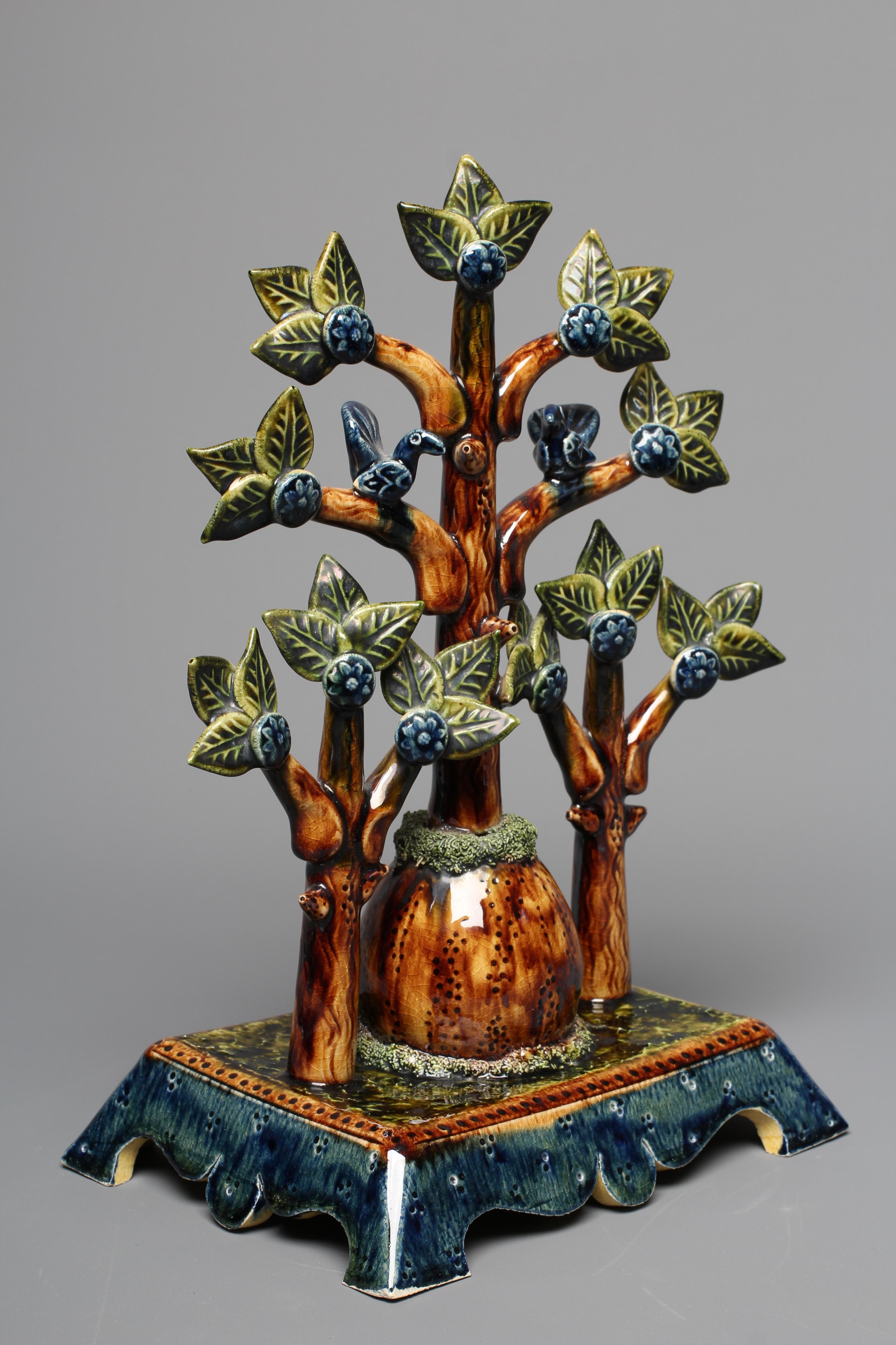 PAUL YOUNG (B.1961) A SLIPWARE TREE modelled as a central tall tree surmounted with two comical Image