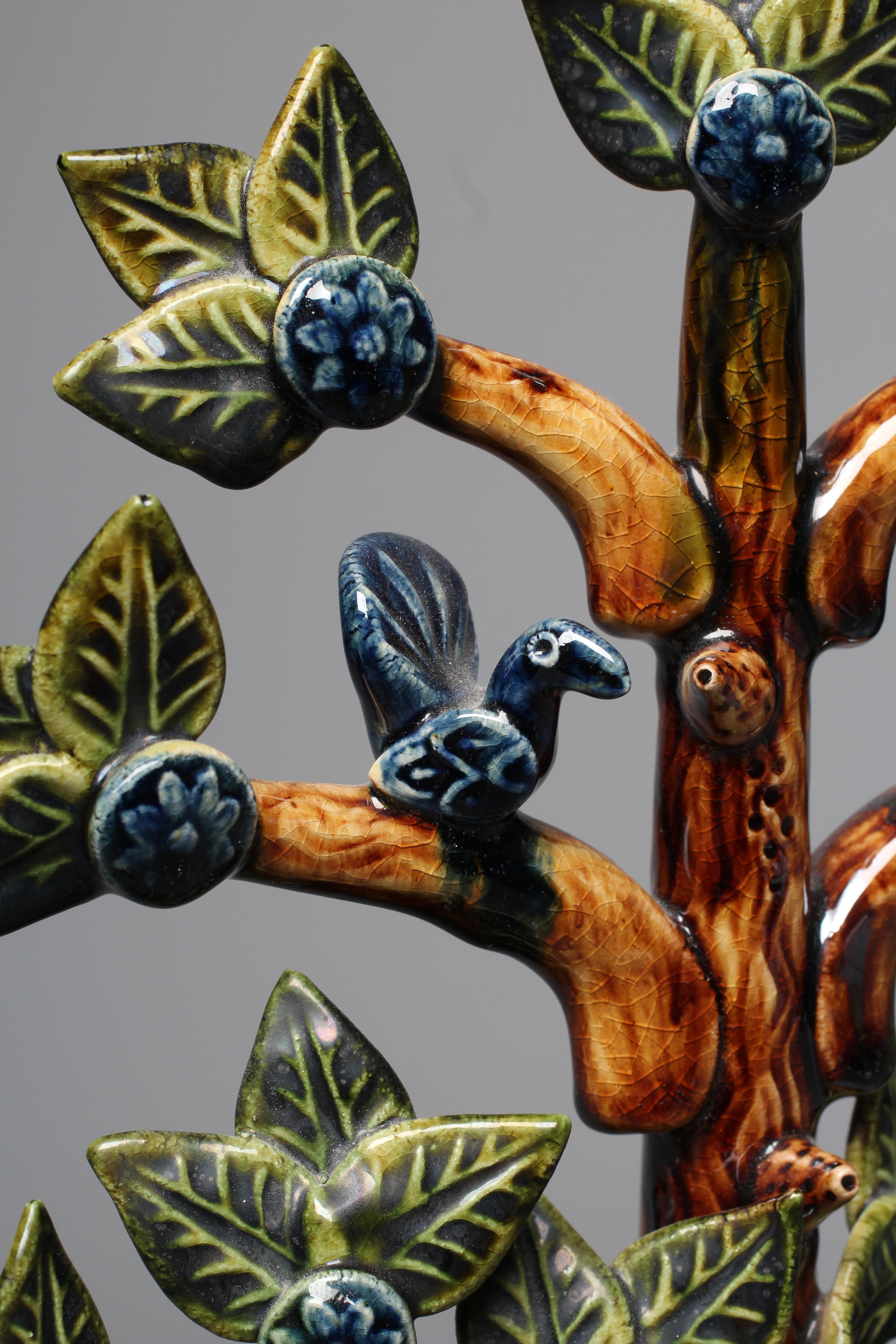 PAUL YOUNG (B.1961) A SLIPWARE TREE modelled as a central tall tree surmounted with two comical Image