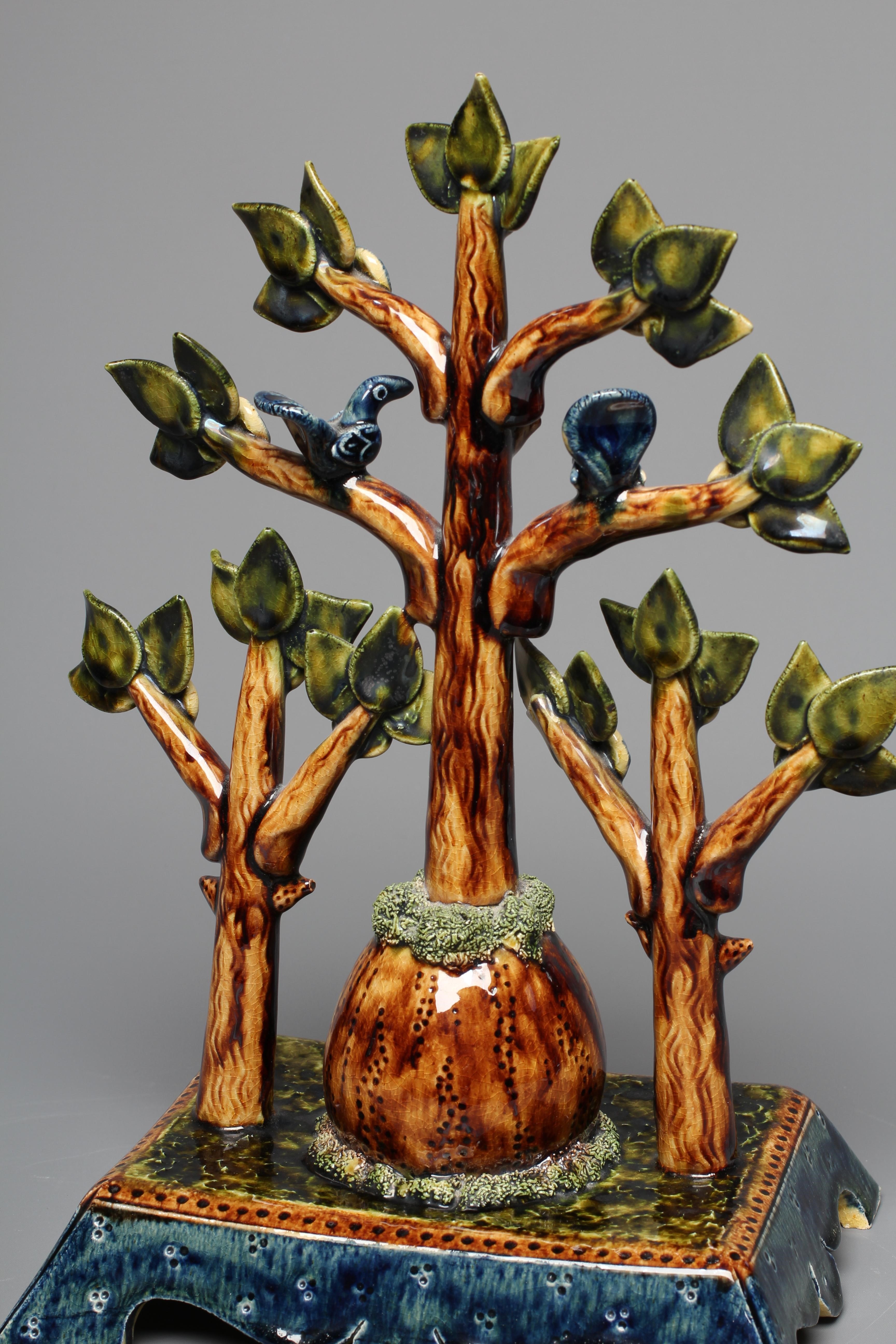 PAUL YOUNG (B.1961) A SLIPWARE TREE modelled as a central tall tree surmounted with two comical Image